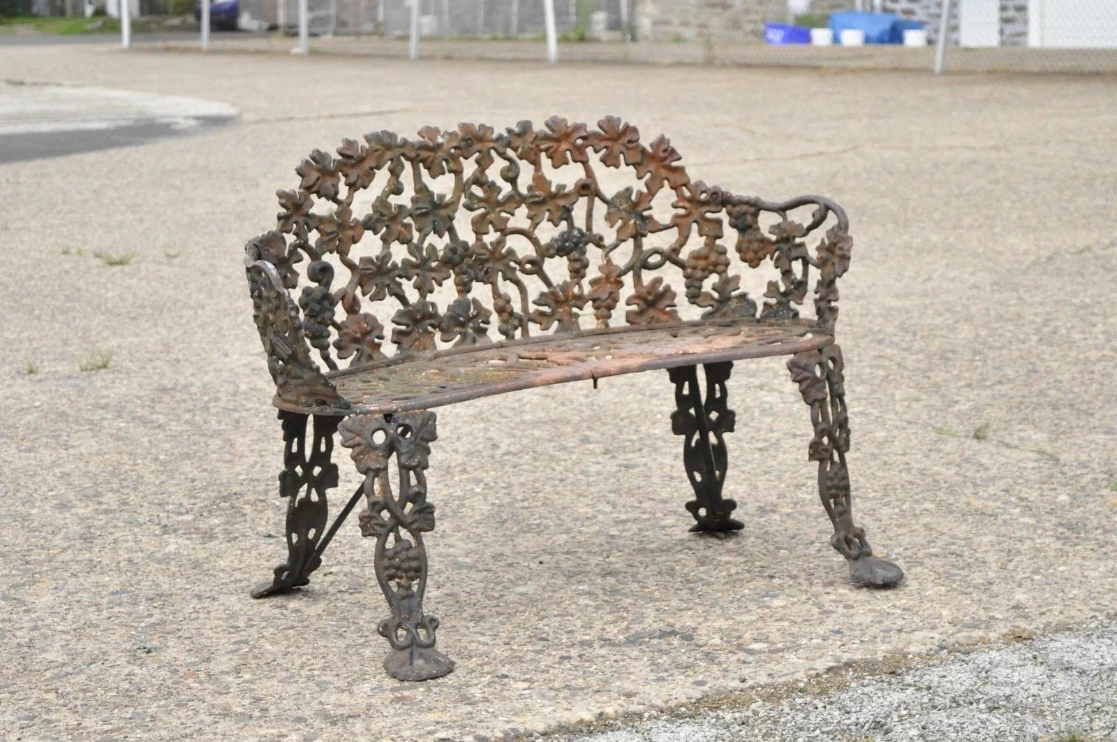 Please message us with your zip code to request a more reasonable domestic U.S. shipping quote.

Antique French Victorian Cast Iron Grapevine & Leaf Small Garden Bench Loveseat. Circa Early 20th Century. Measurements: 28.5