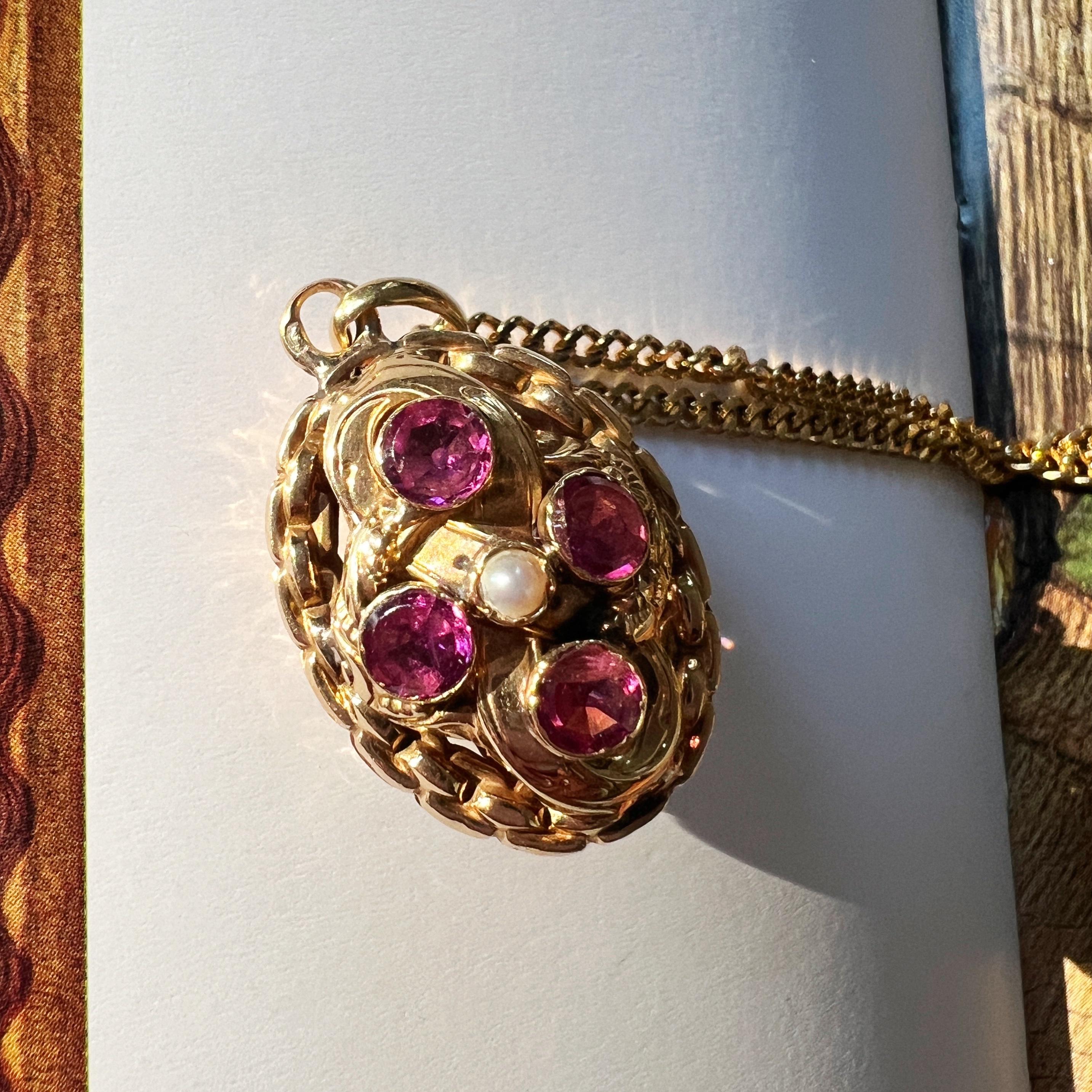 For sale an enchanting 19th-century floral double-sided garnet pendant – a true gem of timeless sweetness.

Adorning each side are four captivating purplish-red almandine garnets, each cradling a delicate pearl at its center. The vivid hues of the
