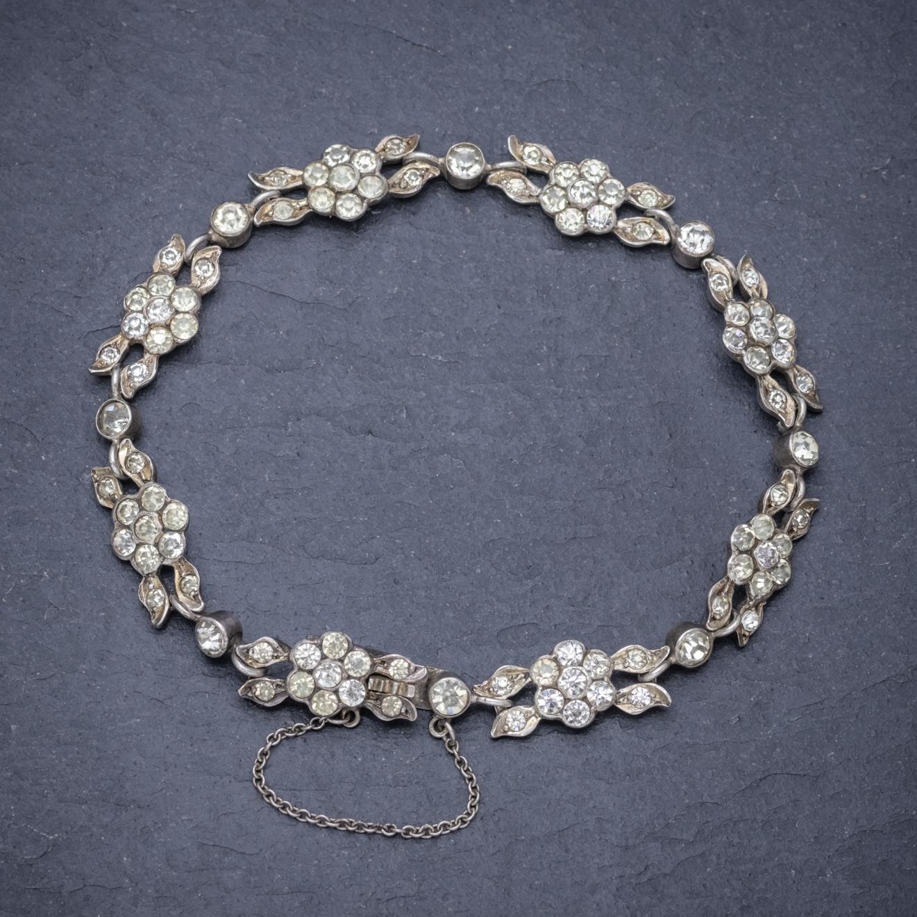 A stunning antique French bracelet from the early 20th century made up of lovely floral links decorated with clear Paste Stones that simulate the beauty and sparkle of Diamonds. 

The piece is modelled in strong Silver and fitted with a box clasp
