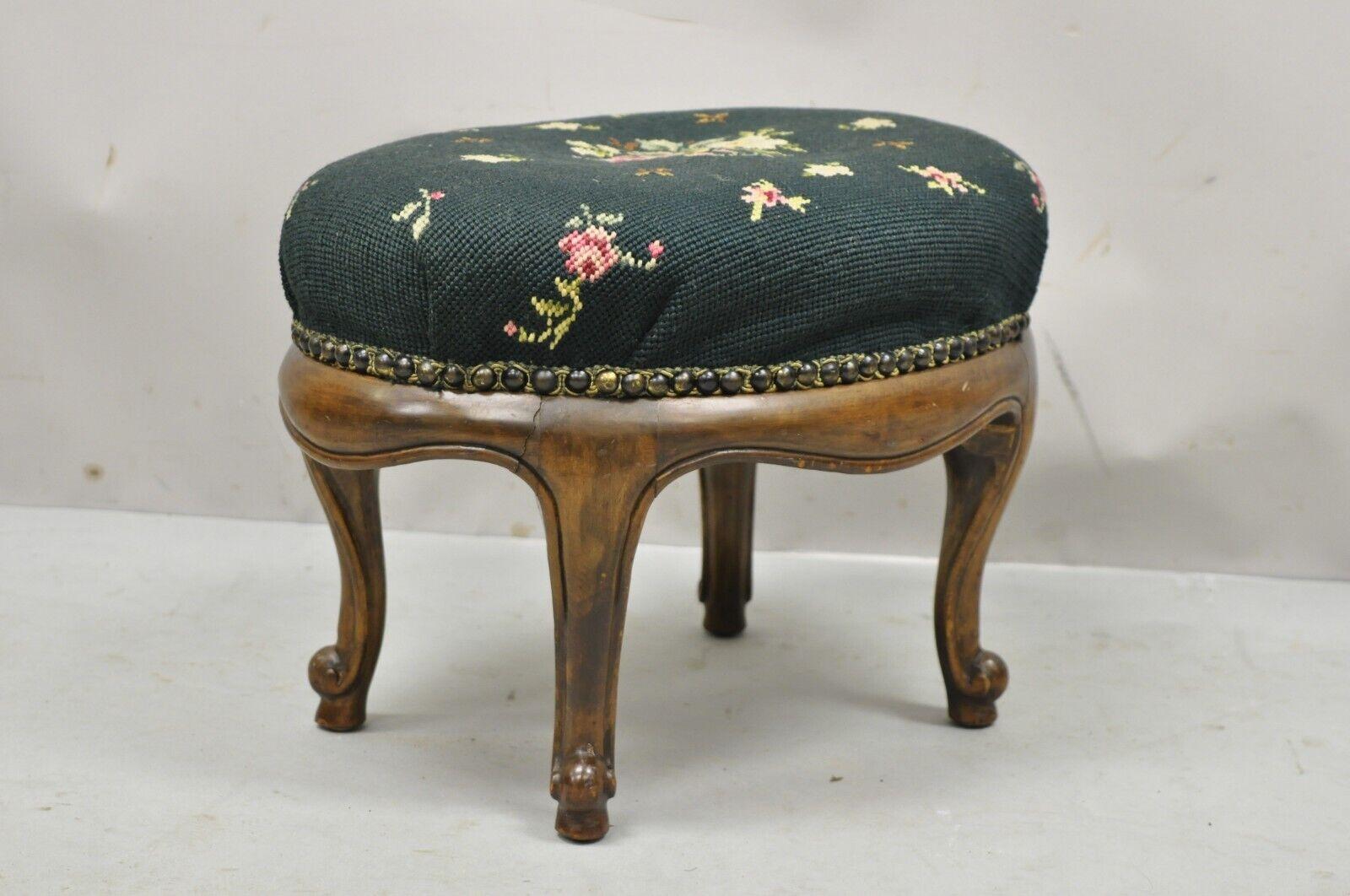 Antique French Victorian green floral needlepoint oval mahogany small footstool ottoman. Item features green floral needlepoint upholstery, nice oval shape, solid wood frame, beautiful wood grain, nicely carved details, cabriole legs, very nice