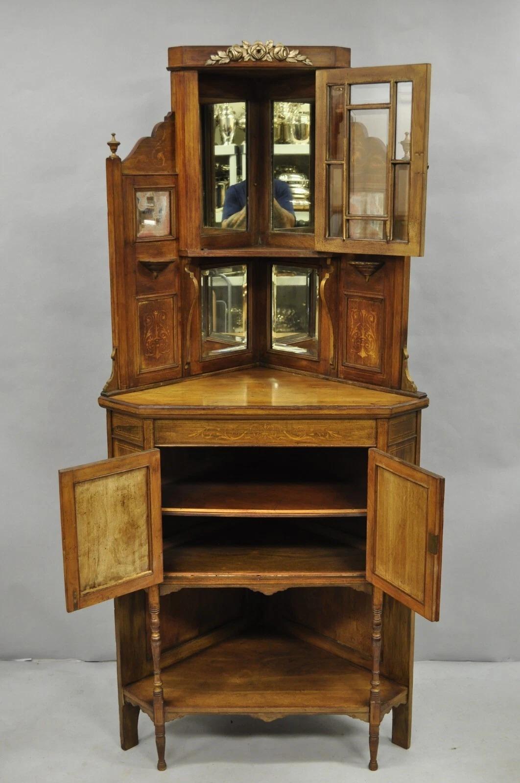 Please message us with your zip code to request a more reasonable domestic U.S. shipping quote.

Antique French Victorian Inlaid Mahogany Corner China Cabinet Display Curio. Item features 2 part construction, bronze floral ormolu, beveled glass, urn