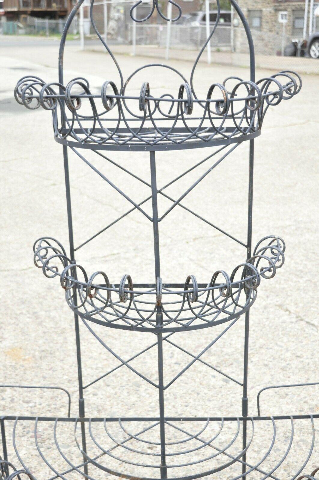 Antique French Victorian iron wire scrolling 3 tier garden Demilune planter. Item features tall 3 tier form, scrolling iron design, cross stretchers, 2 part construction, very nice antique item, great style and form. Circa Early to Mid 1900s.