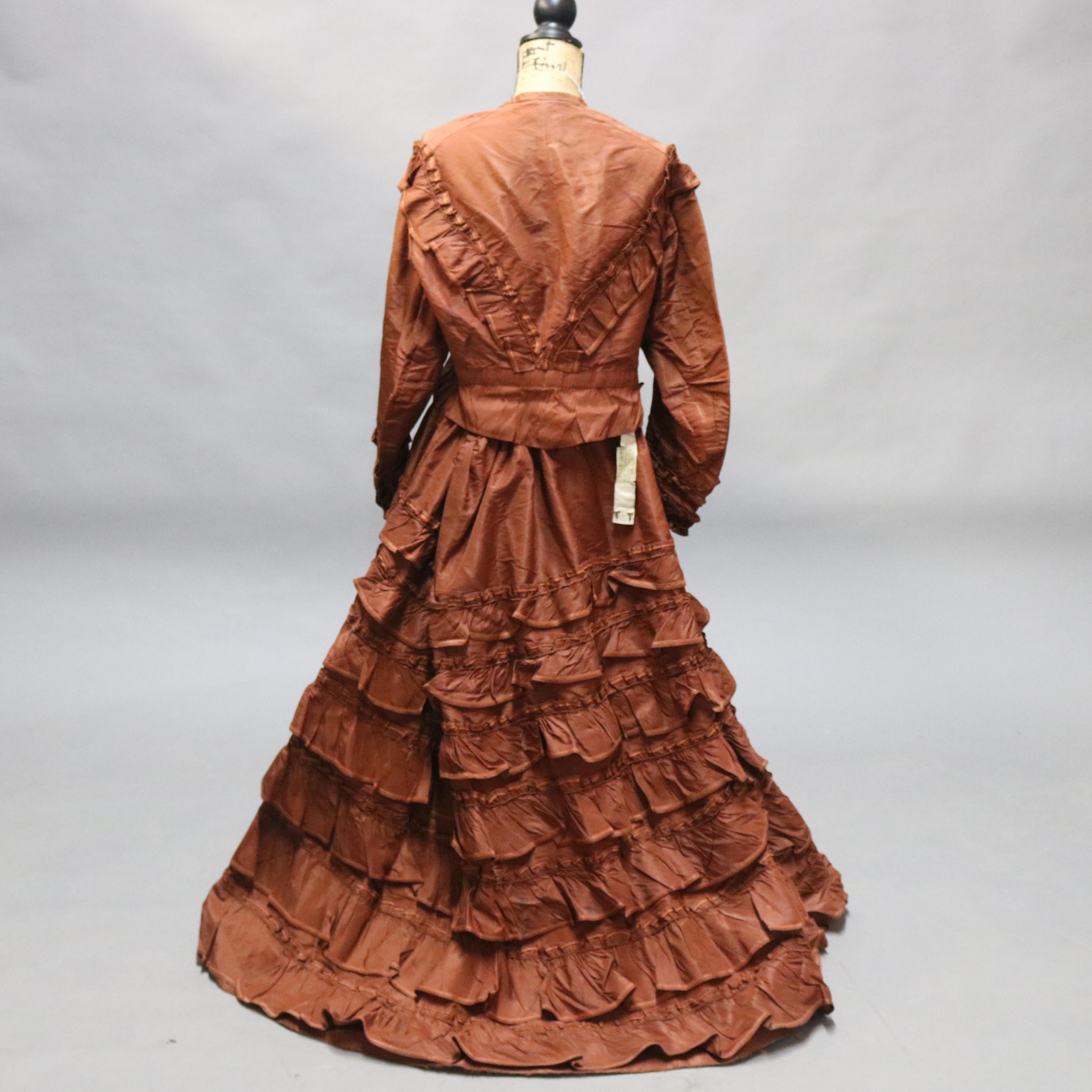 An antique French Victorian lady's day dress by H. Bespaigne Paris offers long sleeves, button front, and ruffles around the skirt, c1880

Measures - 62