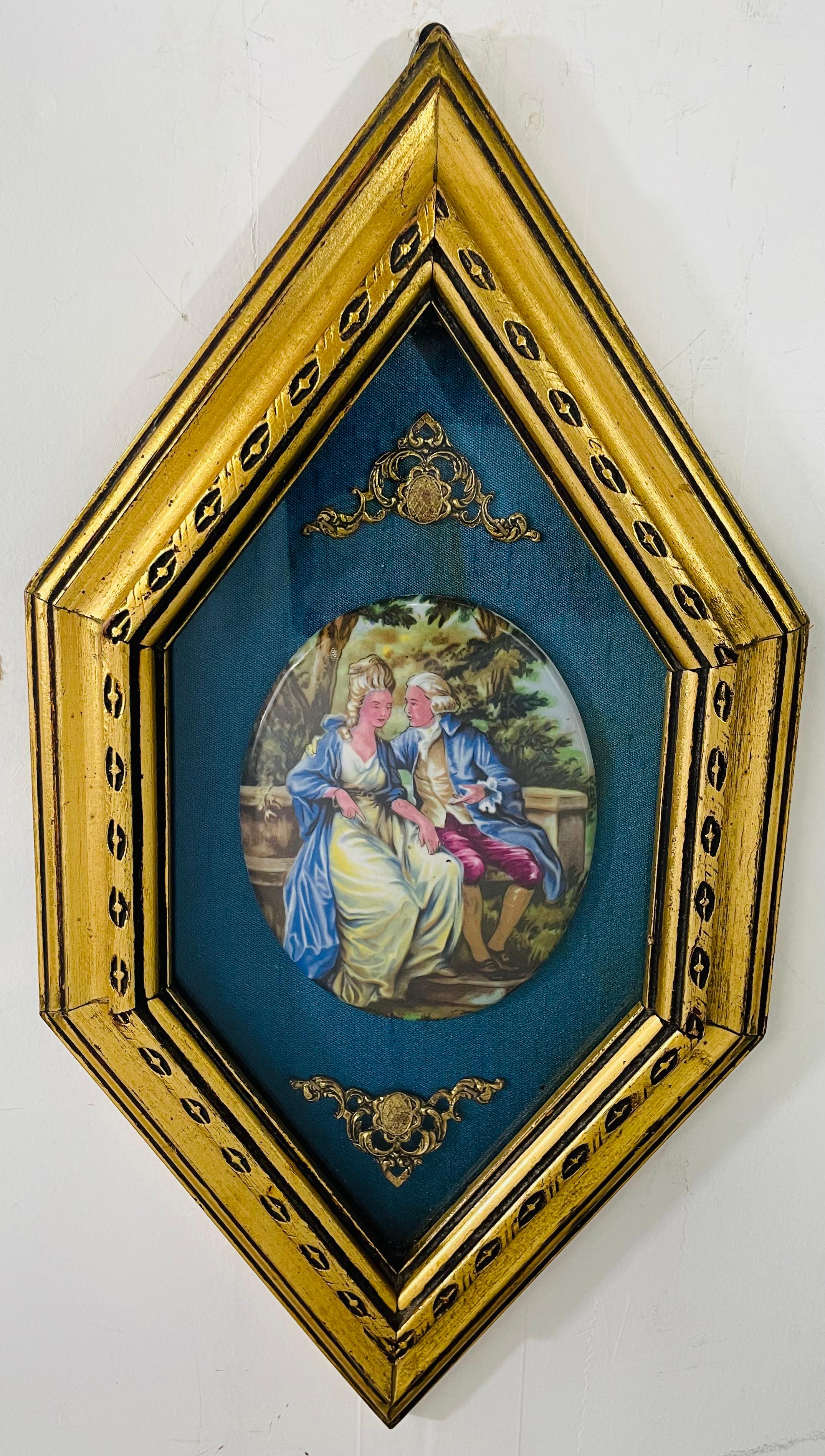 A 19th Century French Victorian porcelain hand painted art depicting a gentleman courting a lady attributed to Limoges . The porcelain oval portrait of the couple beautifully stand out on a blue velvet background. Two elegant acanthus ornaments