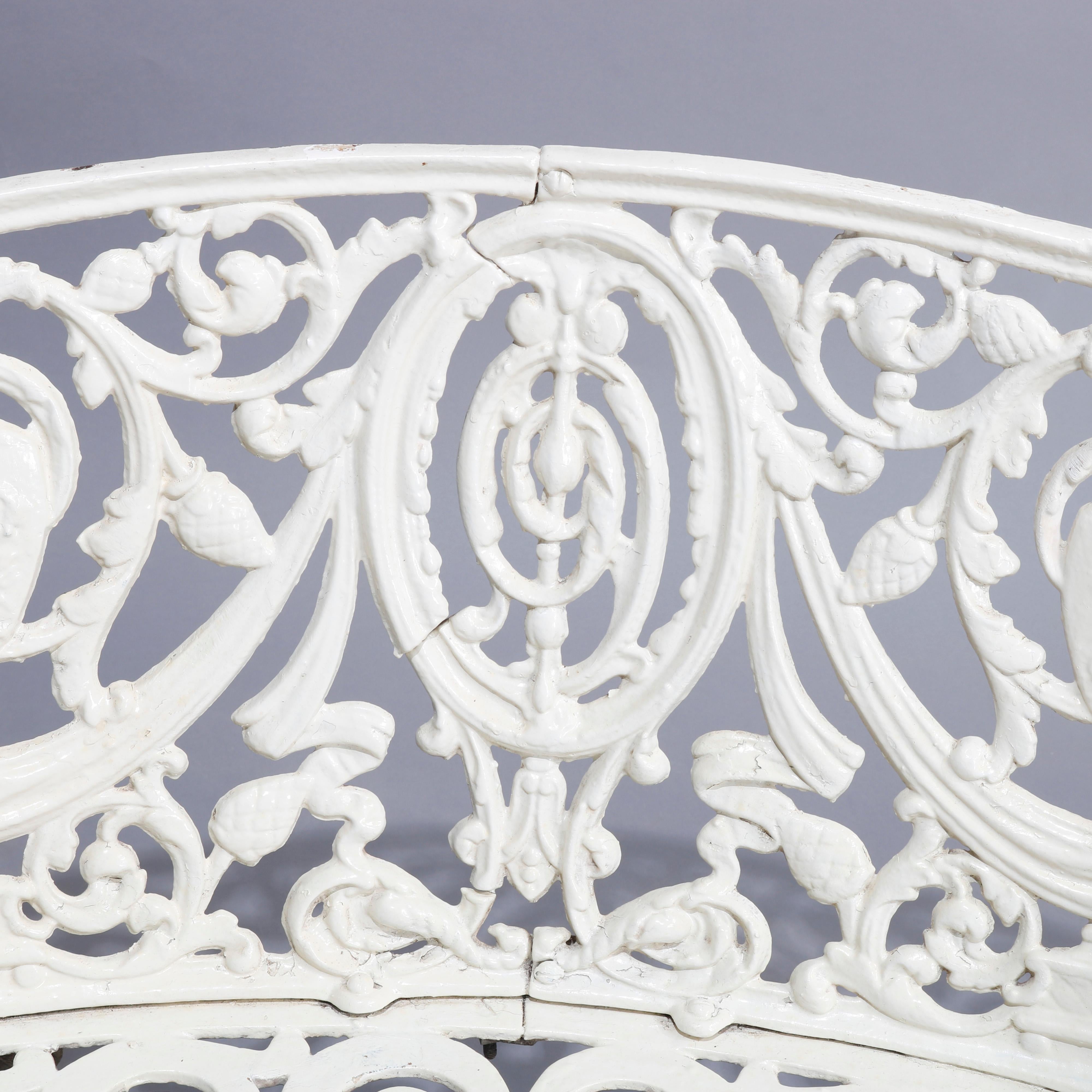 An antique French Victorian white painted cast iron garden bench offers central foliate medallion flanked by urns, drape, scroll and foliate elements, circa 1890

Measures - 37.25