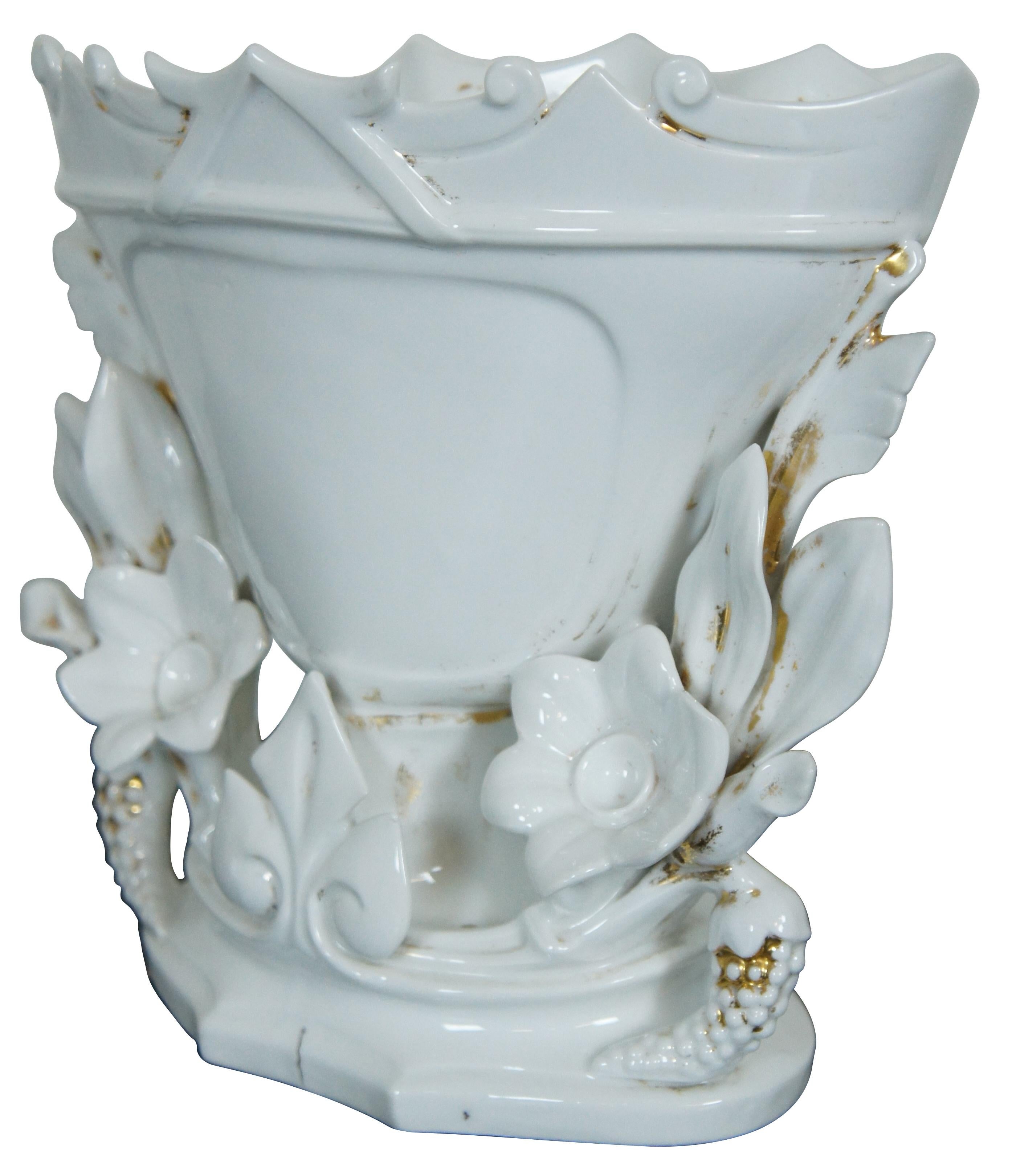 Antique French Vieux Old Paris white porcelain centerpiece vase with a footed goblet or trophy life form with pieced floral accents and scalloped rim.