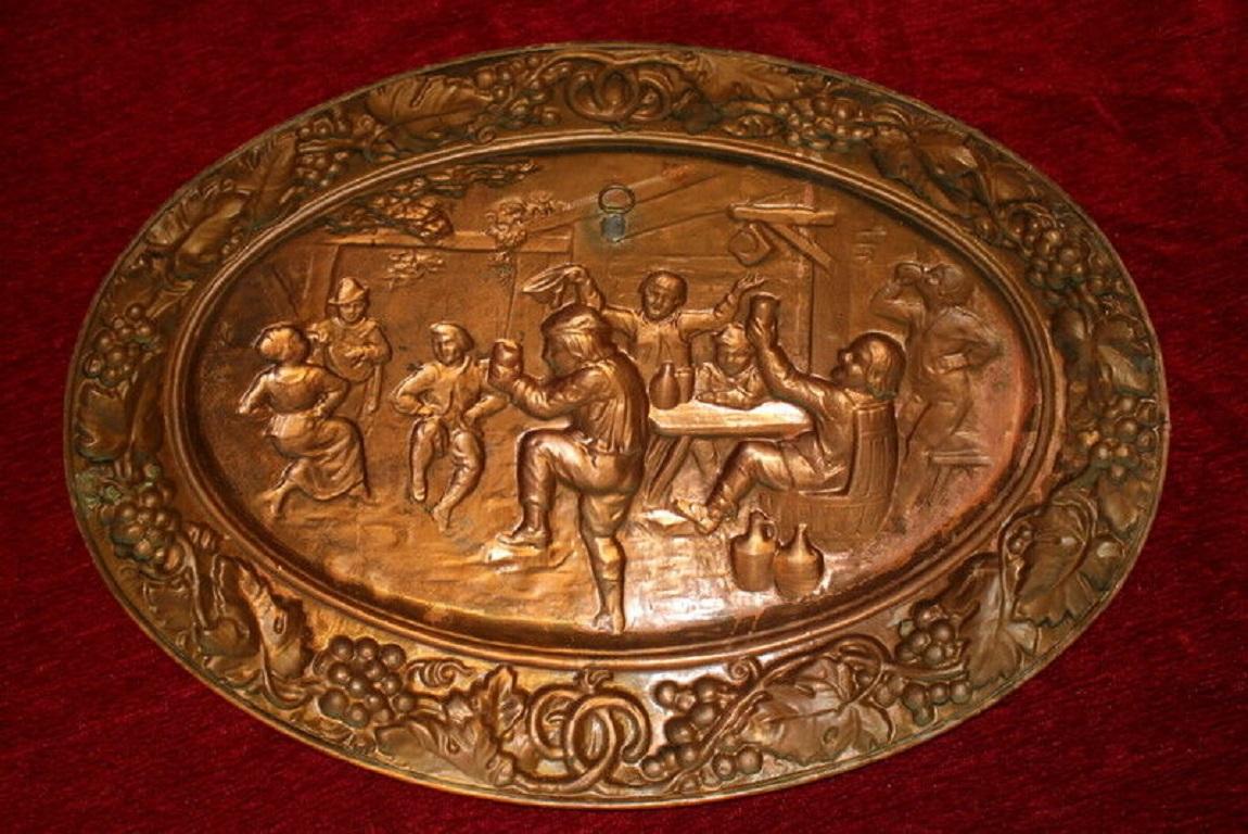 Antique very pretty French Vintage Oval Copper Wall Art embossed Plaque 3-D party with people dancing and drinking wine, around the plaque is designed vine with grapes and grapes leaves. The plaque comes from a vineyard region of