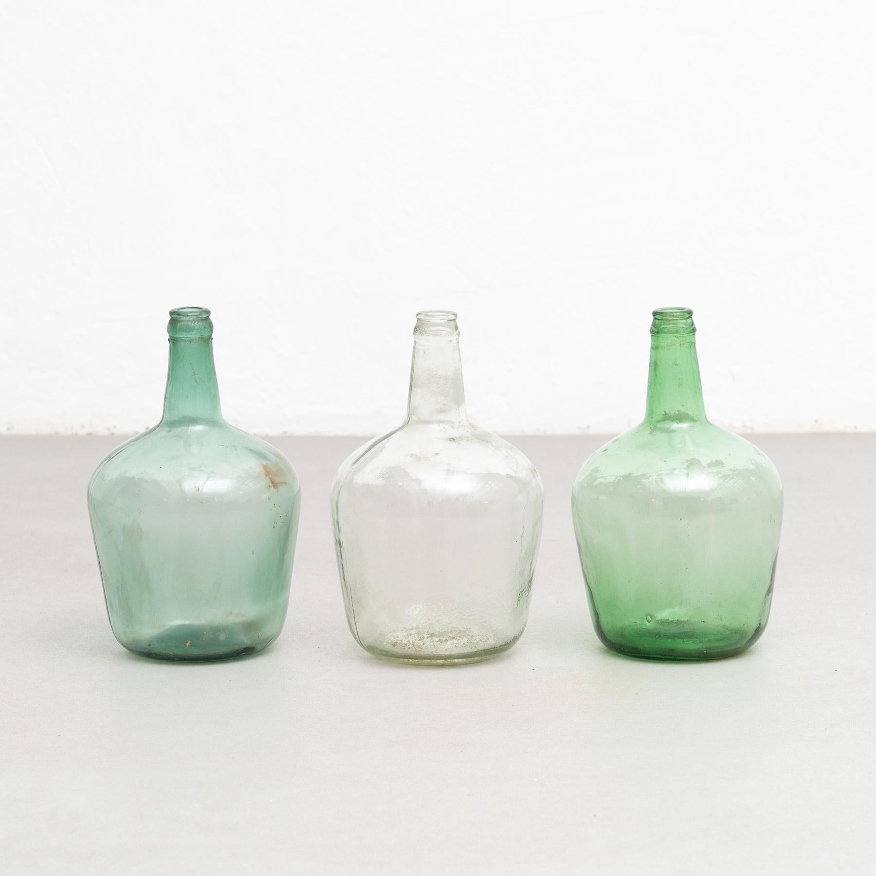 A set of three antique Demijohn glass bottles from Barcelona.

Made by unknown manufacturer in Spain, circa 1950.

In original condition with minor wear consistent of age and use, preserving a beautiful patina.

Materials:

Glass.
