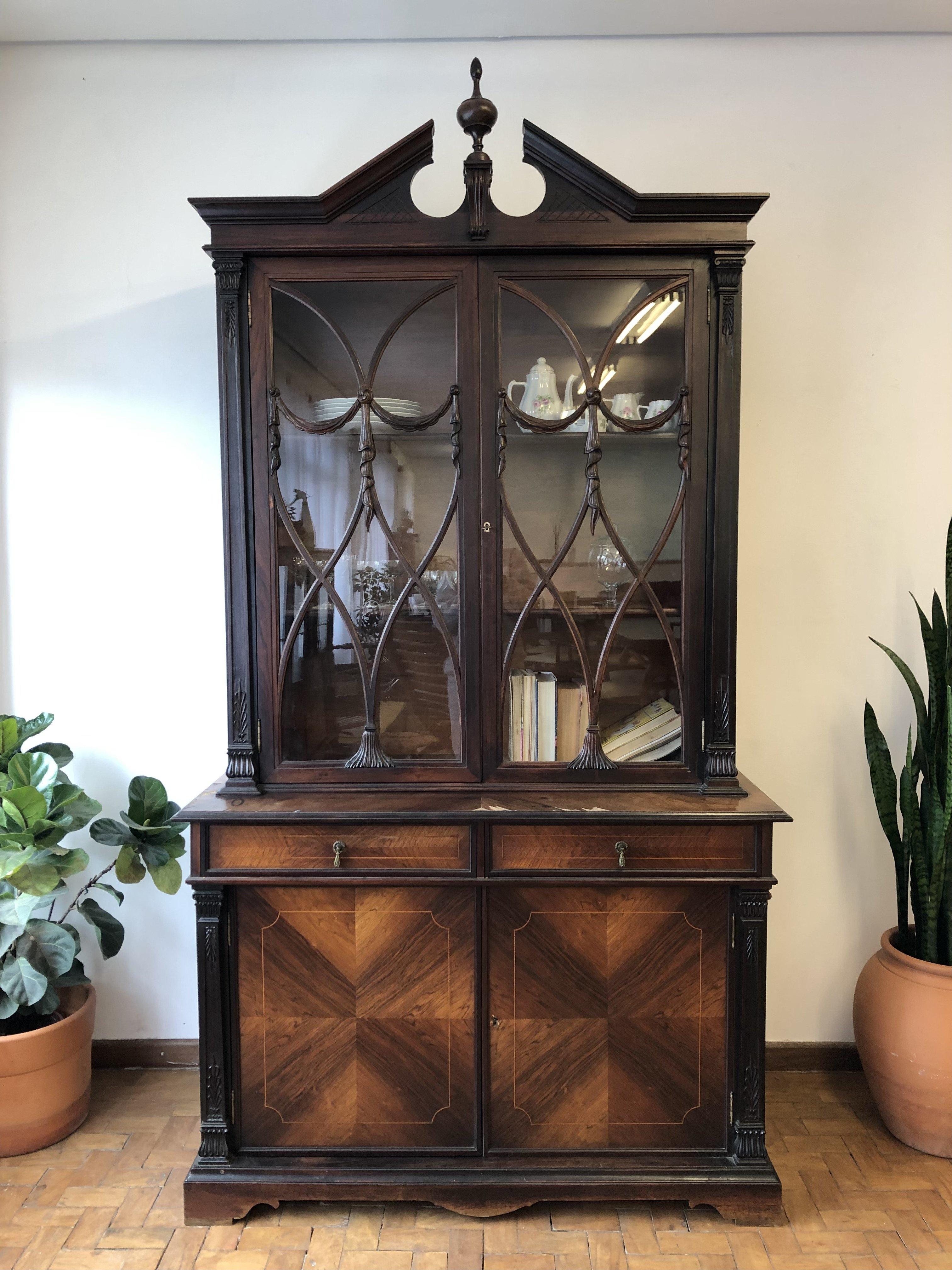 1940s Display cabinet veneered in Rosewood, with 4 doors and 2 drawers. It has iron handles, details in sculpted wood and comes with 2 keys. Very firm, resistant and elegant. Its interior shelves are removable and the upper doors have framed glass.