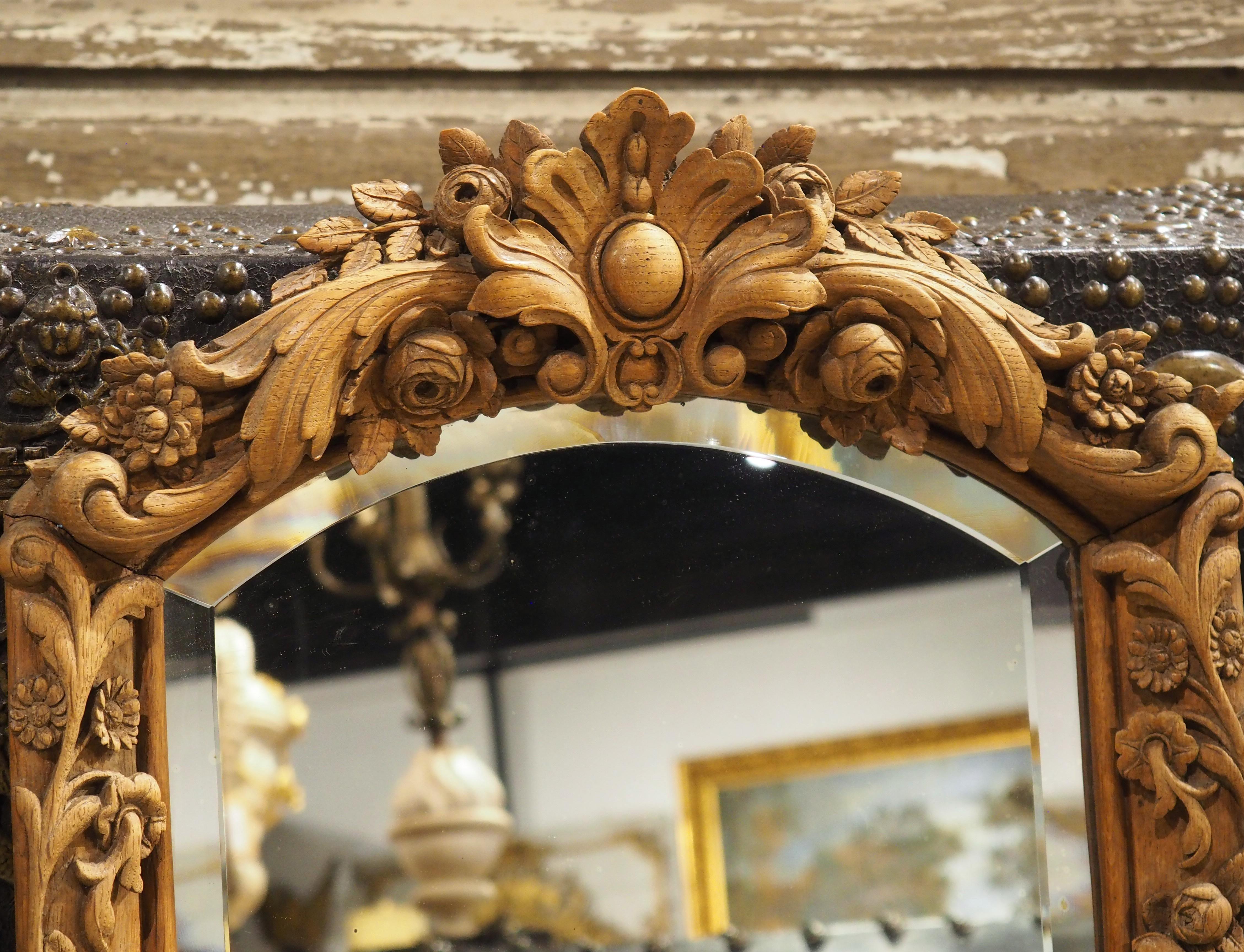 More information coming soon…

This small French wall mirror, which dates to the 1800s, features a shaped and beveled piece of glass surrounded by a well-carved frame.  The oak wood, which has a light brown hue, is adorned with meandering floral