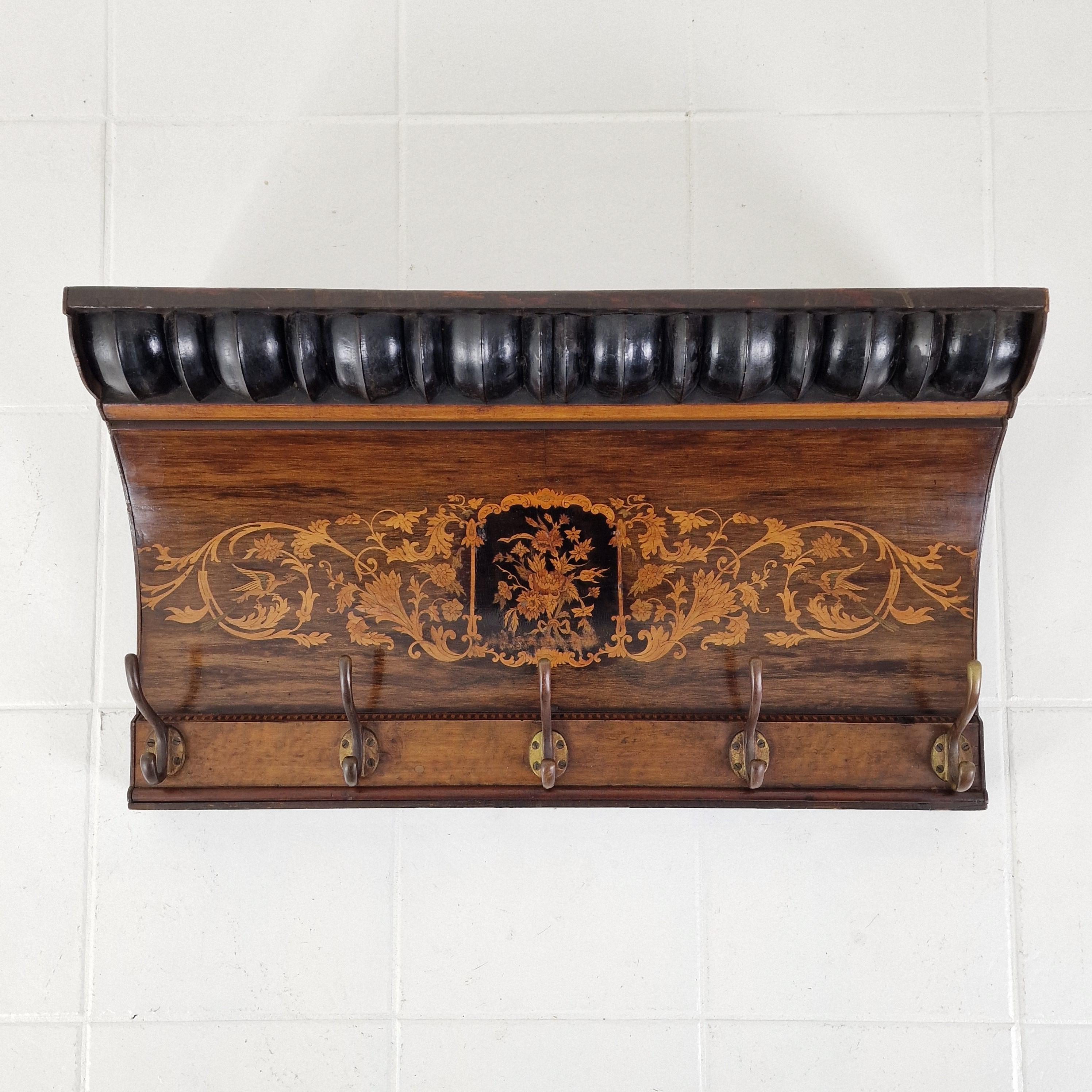 This refined antique coat rack originates from France and dates to the late 19th century. Crafted from solid wood, it features exquisite hand-inlaid floral marquetry, showcasing the exceptional craftsmanship and decorative artistry typical of the