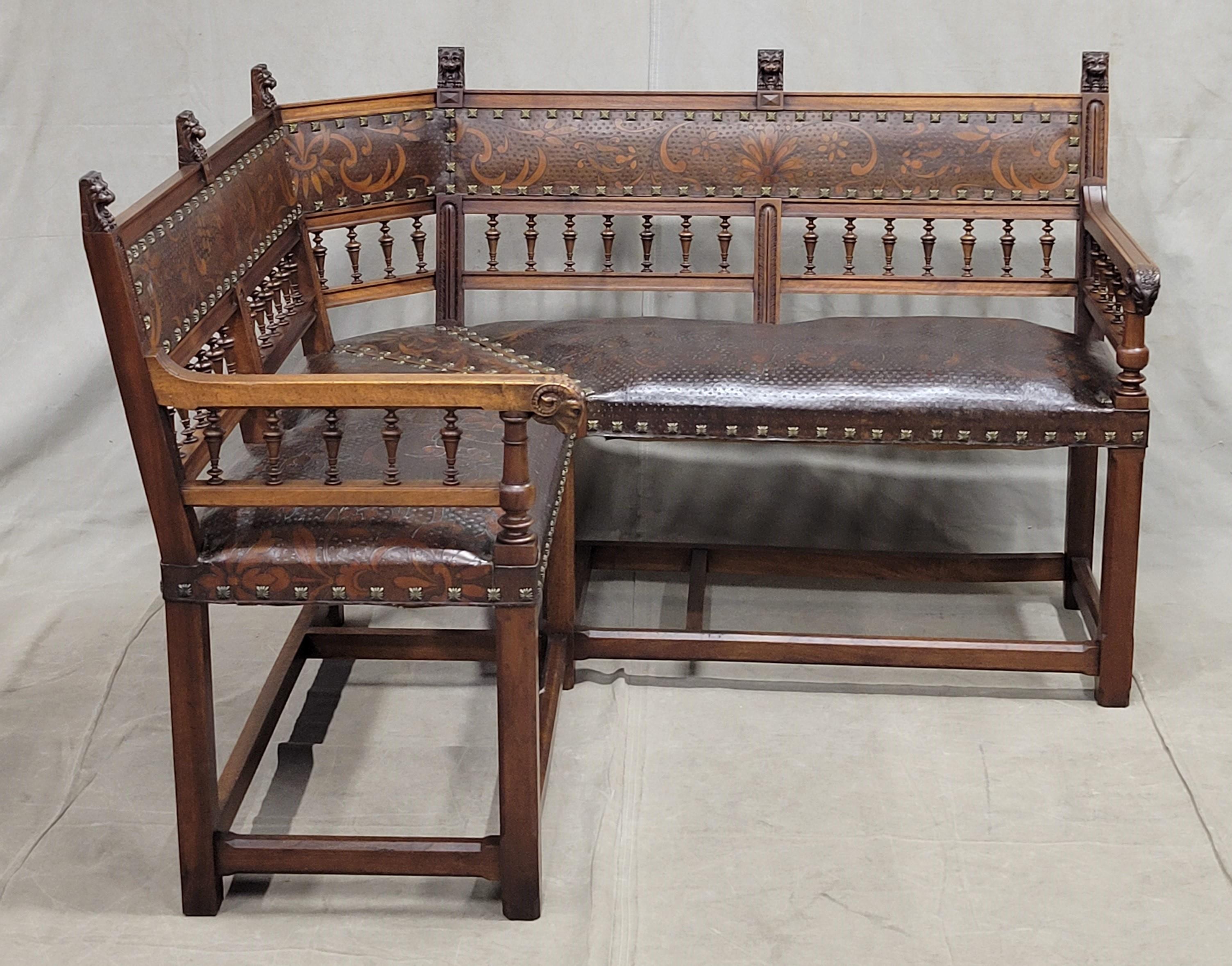 A truly rare find! This antique French banquette bench was carved out of walnut and upholstered with Fine tooled leather and brass Renaissance style tacks. Leather is in immaculate condition. Wood is in excellent condition with just some old,