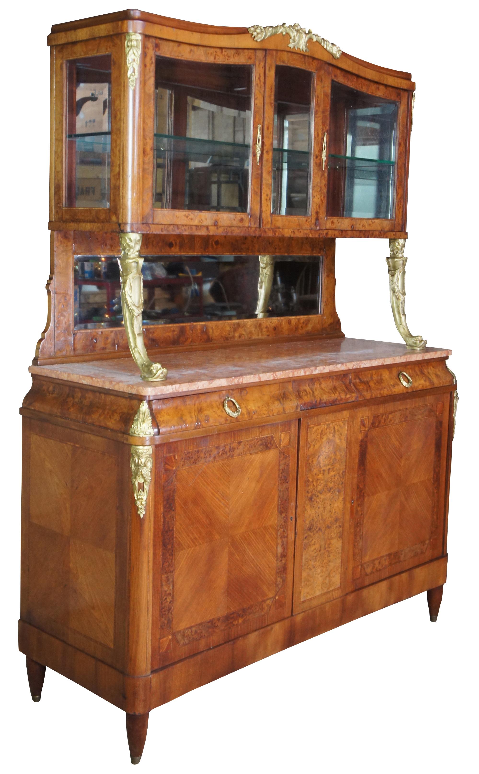 Beautiful walnut burr sideboard. Features a travertine top with bronze delphin mounts that steps up into the cupboard portion of the cabinet. The top includes a glass shelf for storage and a mirroed backing for display. The cabinet is adorned with