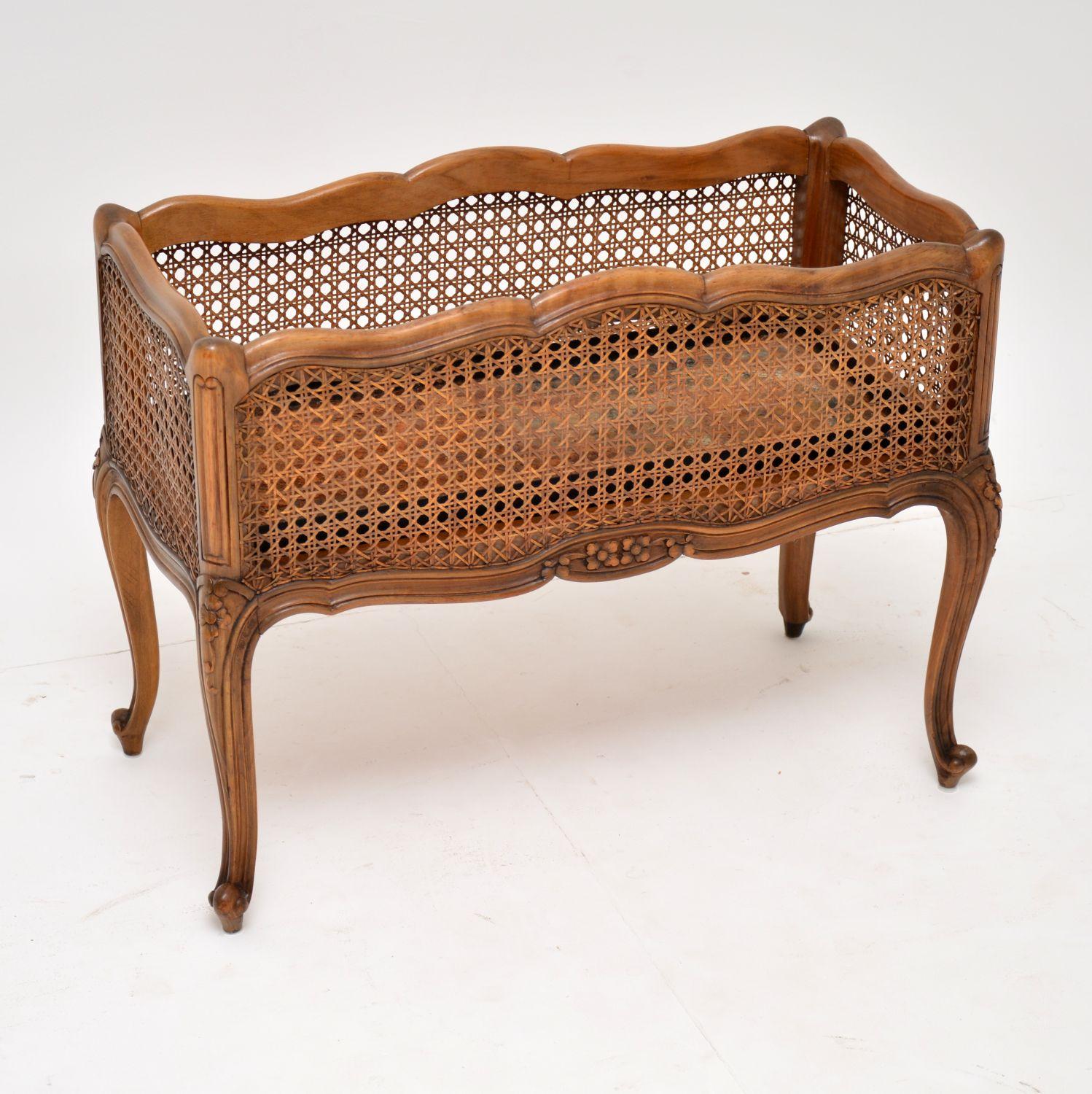 Very useful antique French style walnut plant holder with cane side panels, in good original condition and dating to circa 1890-1910 period.

It has a nice warm color, with lots of character, lovely shaping all-over and the carvings are crisp. The