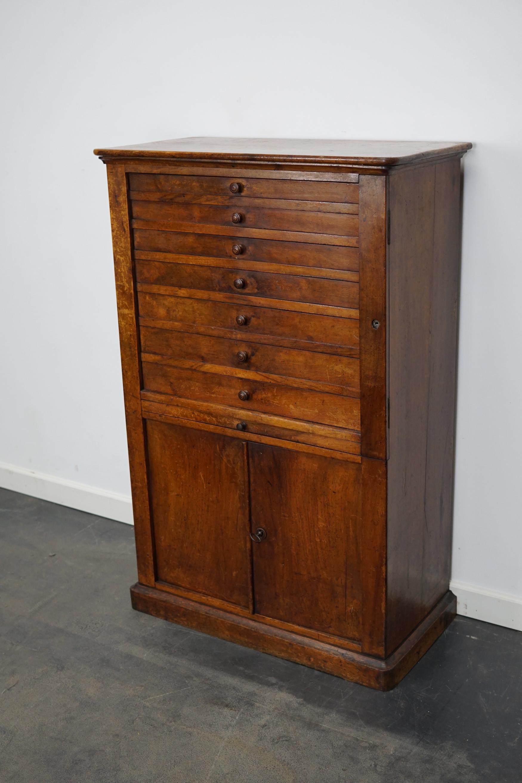 This clock / watchmakers cabinet was designed and made in the early 20th century in France. It features 7 walnut fronted drawers in different sizes: DWH 23.5 x 48 x 2 / 3 / 3.5 / 4 / 4.5 cm.