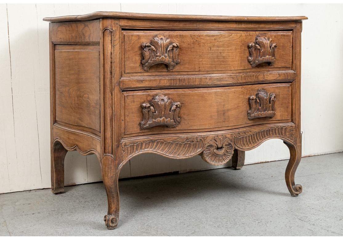 French Provincial Antique French Walnut Commode With Elaborate Carved Pulls For Sale
