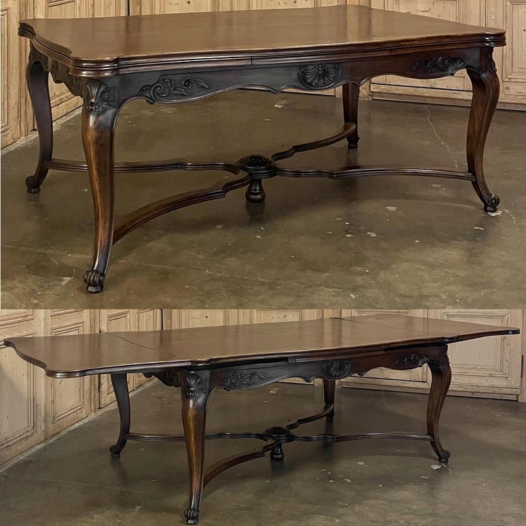 Antique French walnut draw leaf dining table opens to almost banquet table length in an instant! This clever design, conceived during the 19th century, but made a sensation in the 20th century, consists of two leaves that tuck under the main table