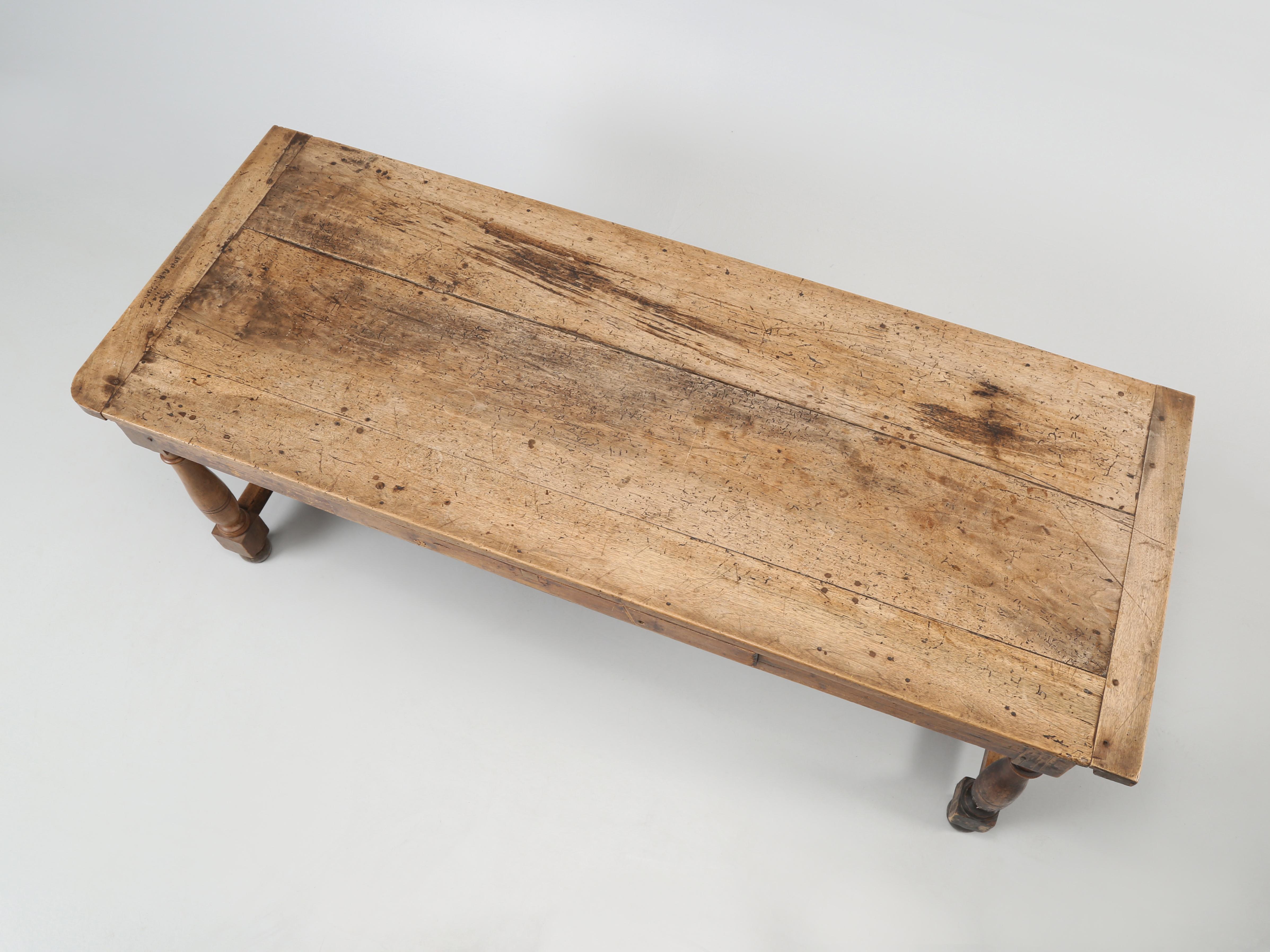 French antique farm table made probably during the mid-1800’s from wide walnut boards. This antique French farm table, as you can clearly see was used as a family’s daily dining table and was never restored, which is exactly why we love it so much.