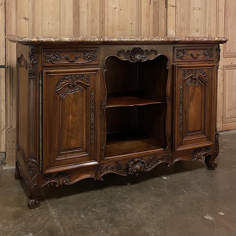 Antique French Walnut Louis XIV Marble Top Display Buffet ~ Sideboard is a masterpiece of the cabinetmaker's art! Rendered from sumptuous walnut, it features an intriguing design that comprises two cabinets flanking an open display section in the