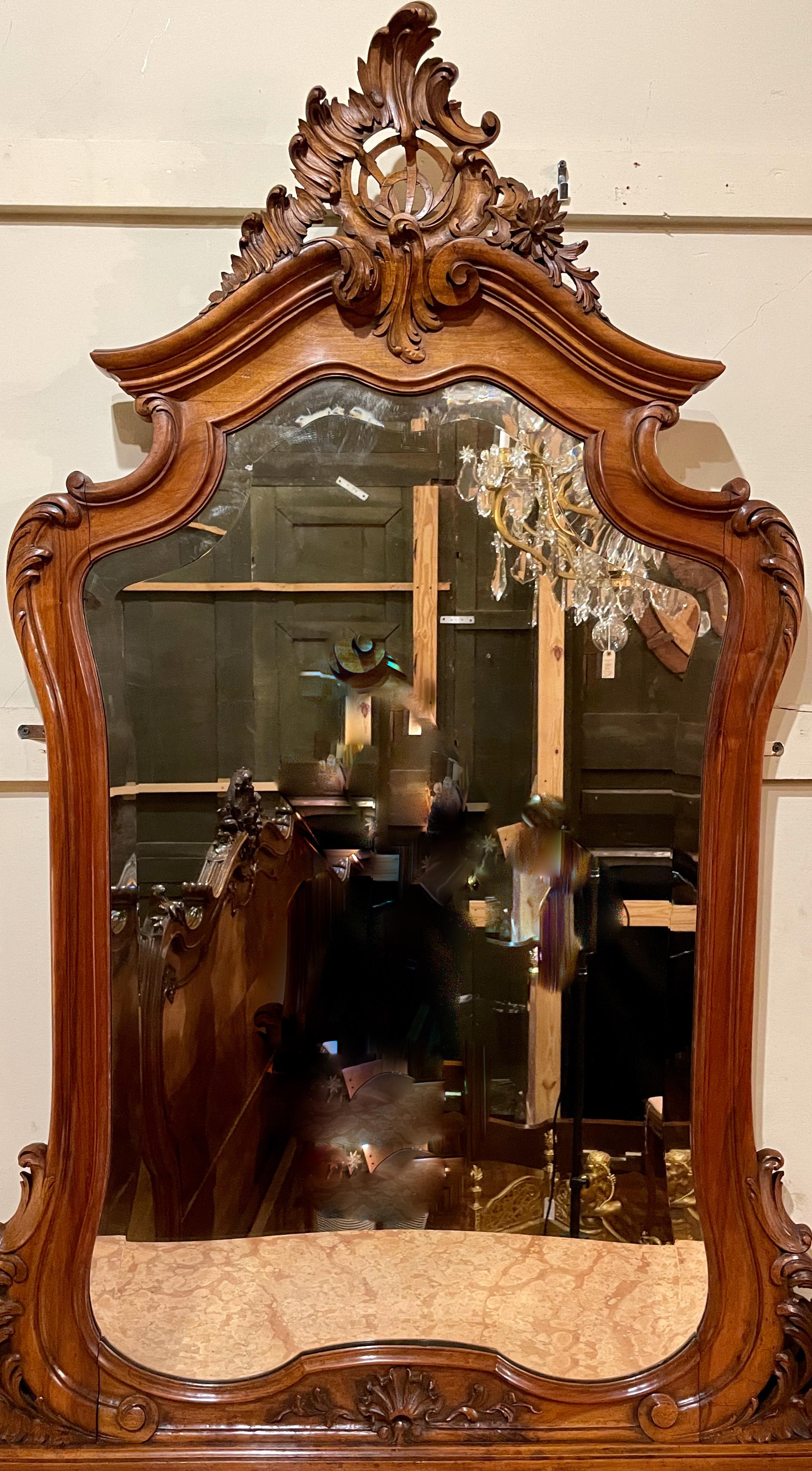 Antique handsome walnut and marble bombè chest of drawers with beveled mirror, circa 1885-1895.