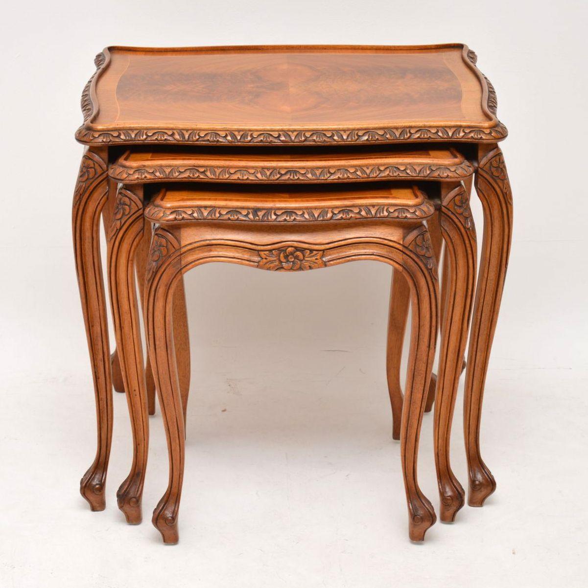 Antique French style walnut nest of three tables in excellent condition and dating to circa 1930s period. They are of high quality and have fine carvings around the shaped tops, between and on the tops of the solid walnut cabriole legs. The table