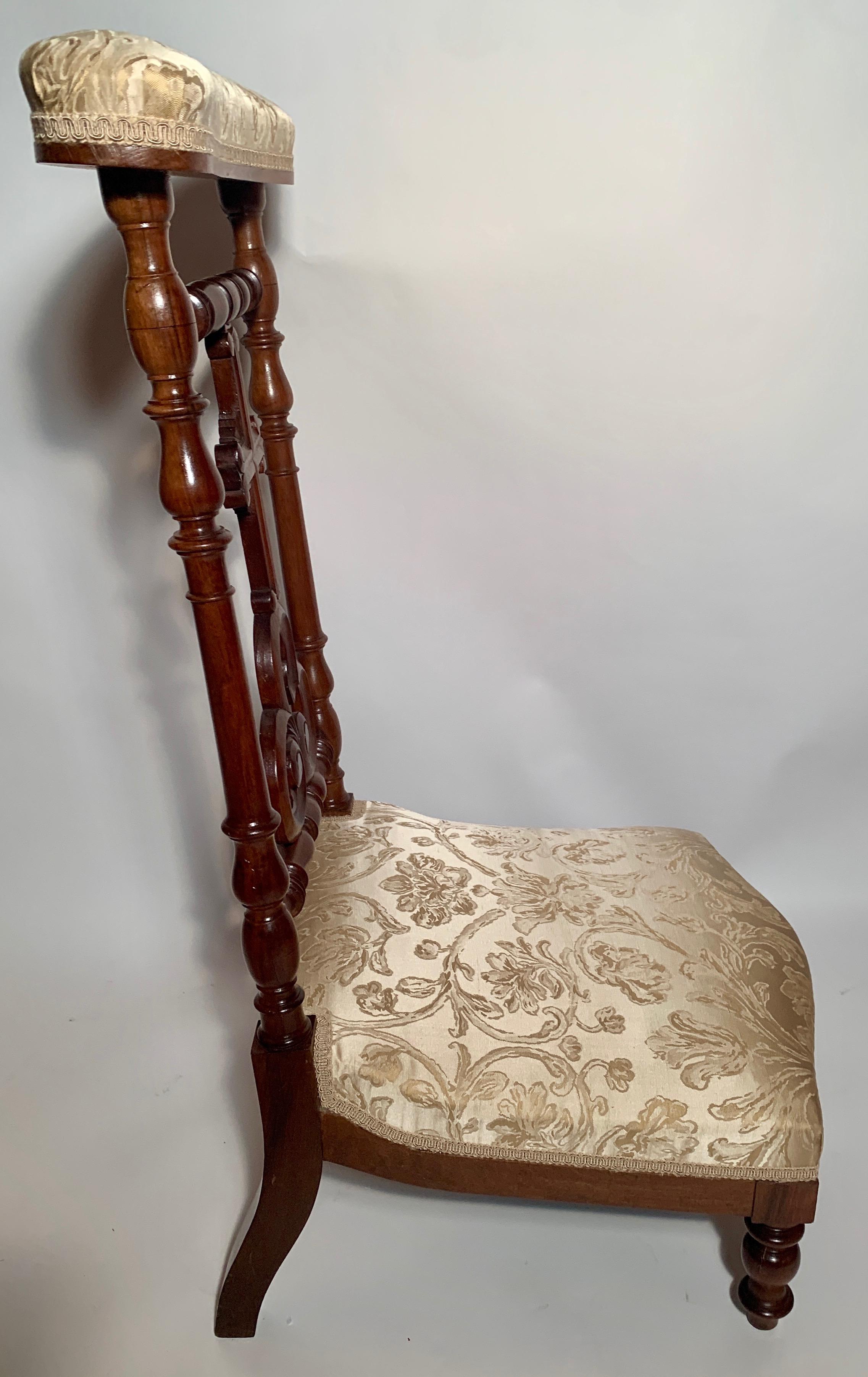 A prie-dieu is a small piece of furniture used in the home for kneeling in prayer. They were often found in bedrooms or front parlors in homes of the period.

 