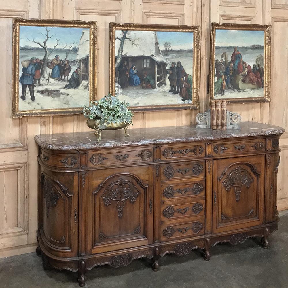 Antique French Regence marble-top buffet was sculpted from fine French walnut, and features rounded sides for a pleasing visual effect that also is very traffic-friendly! Stylized shell, floral and foliate motifs abound from the back corner all