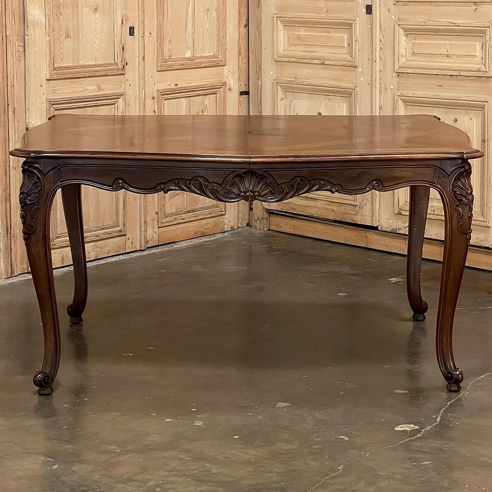 Antique French Walnut Regence Style Dining Table is a classic example of fine craftsmanship utilizing exquisite indigenous woods for an opulent effect. The subtle contours of the top's framework resemble the violin shape, with beveled edges all