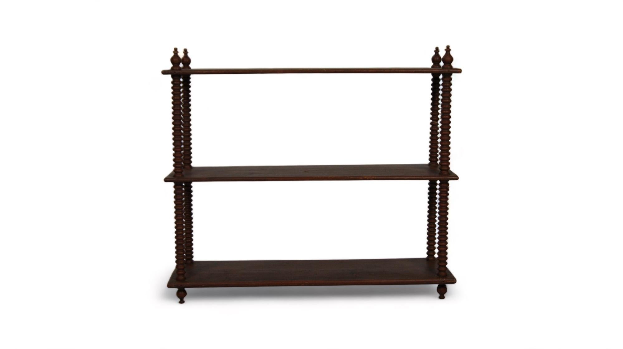 The antique French walnut shelf is a sublime piece that embodies the essence of refinement and classic elegance. With its distinctive design and rich history, this bookcase stands as a masterpiece of exquisite craftsmanship and taste.

Walnut, with