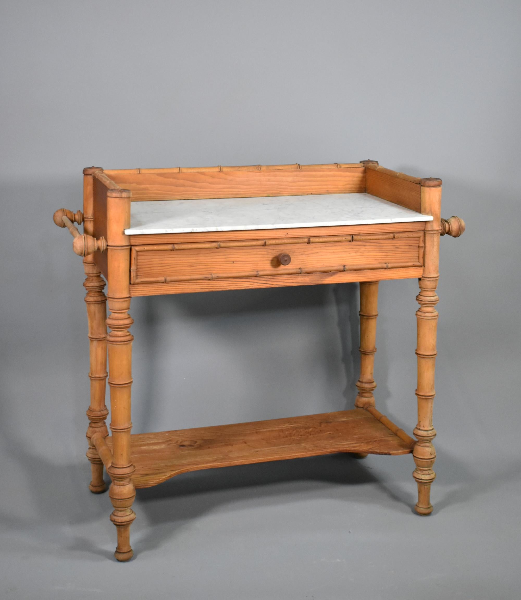 Antique French Washstand Napoleon III Style 

A pretty faux bamboo and pine washstand featuring a variegated grey and white veined Carrara marble top inset into a pine surround. 

The piece exudes character and charm and would add a touch of