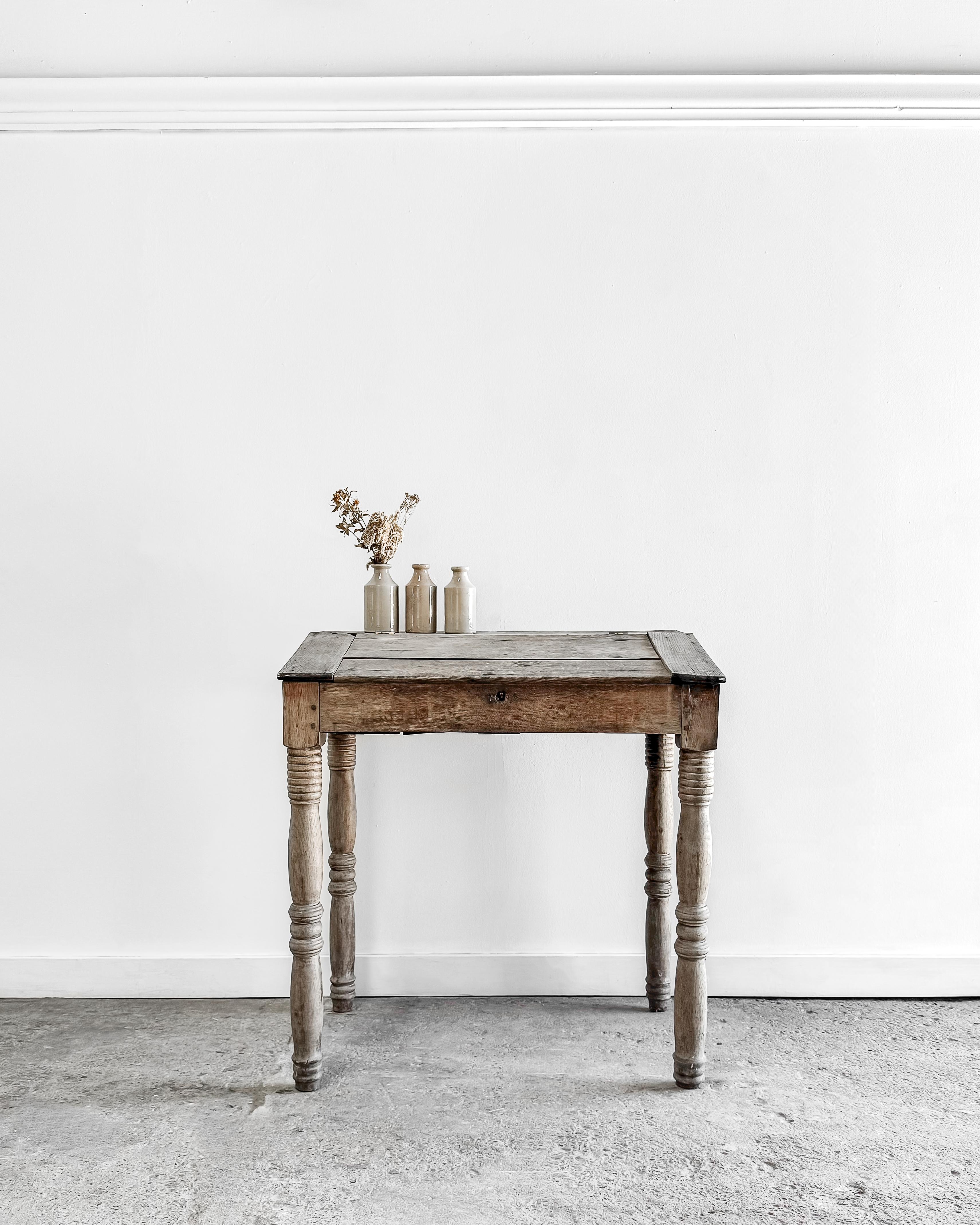 This lovely petite slant-top writing desk is a true gem that exudes the rustic yet refined charm of the French countryside. Crafted from solid oak, it boasts an enchanting time-worn patina that tells the story of its rich history and the many hands