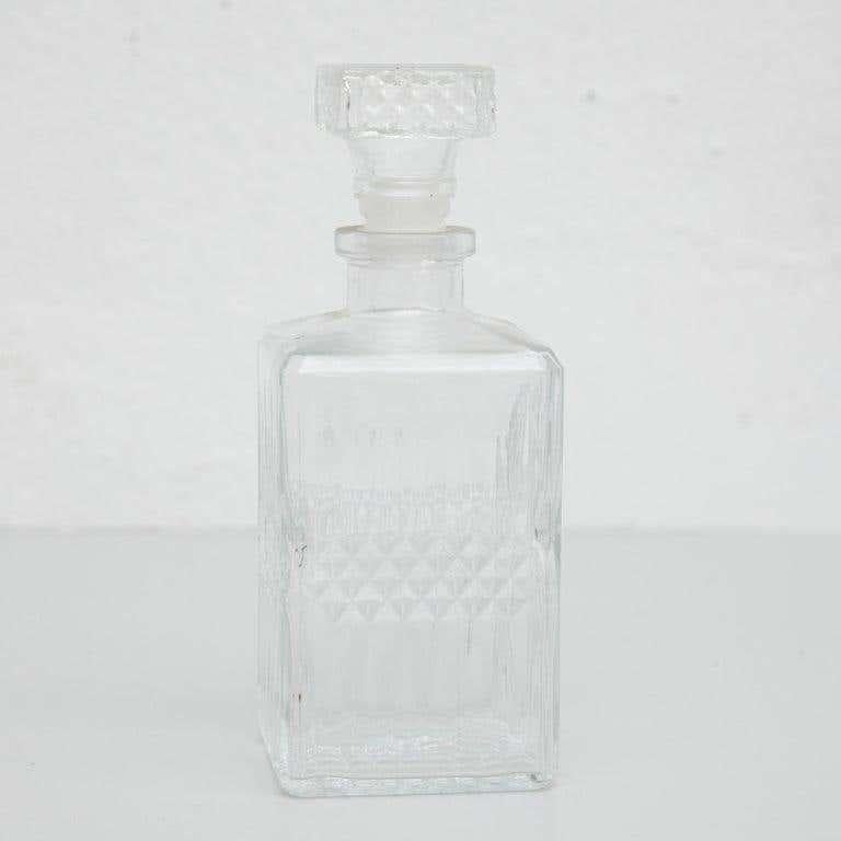 Antique French whisky glass bottle. By unknown manufacturer, France, circa 1950. In original condition, with minor wear consistent with age and use, preserving a beautiful patina.  Materials: glass  Dimensions: D 9 cm x W 9 cm x H 24 cm.  