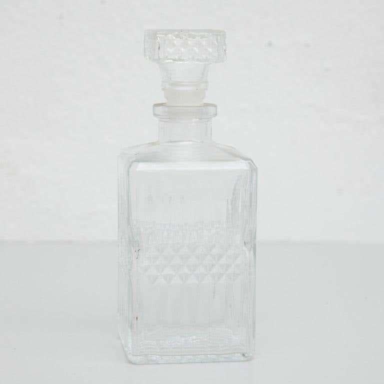Antique French whisky glass bottle.
By unknown manufacturer, France, circa 1950.
In original condition, with minor wear consistent with age and use, preserving a beautiful patina.

Materials:
glass

Dimensions:
D 9 cm x W 9 cm x H 24 cm.
 