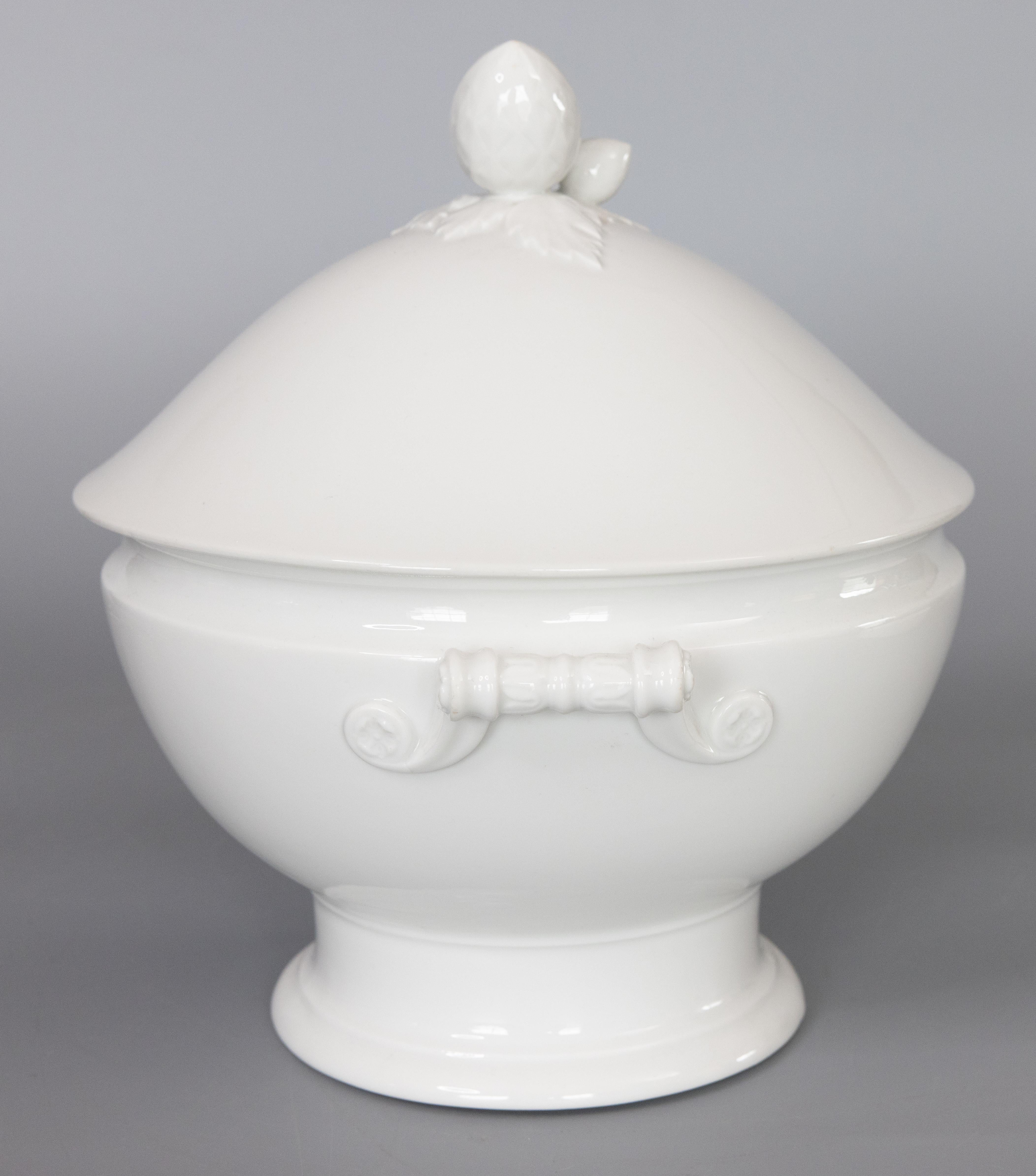 A gorgeous antique French white ironstone lidded soup tureen, circa 1900. No maker's mark. This fine soup tureen has a decorative finial and lovely ornate handles. It's perfect for display or serving at your next party.

DIMENSIONS
11