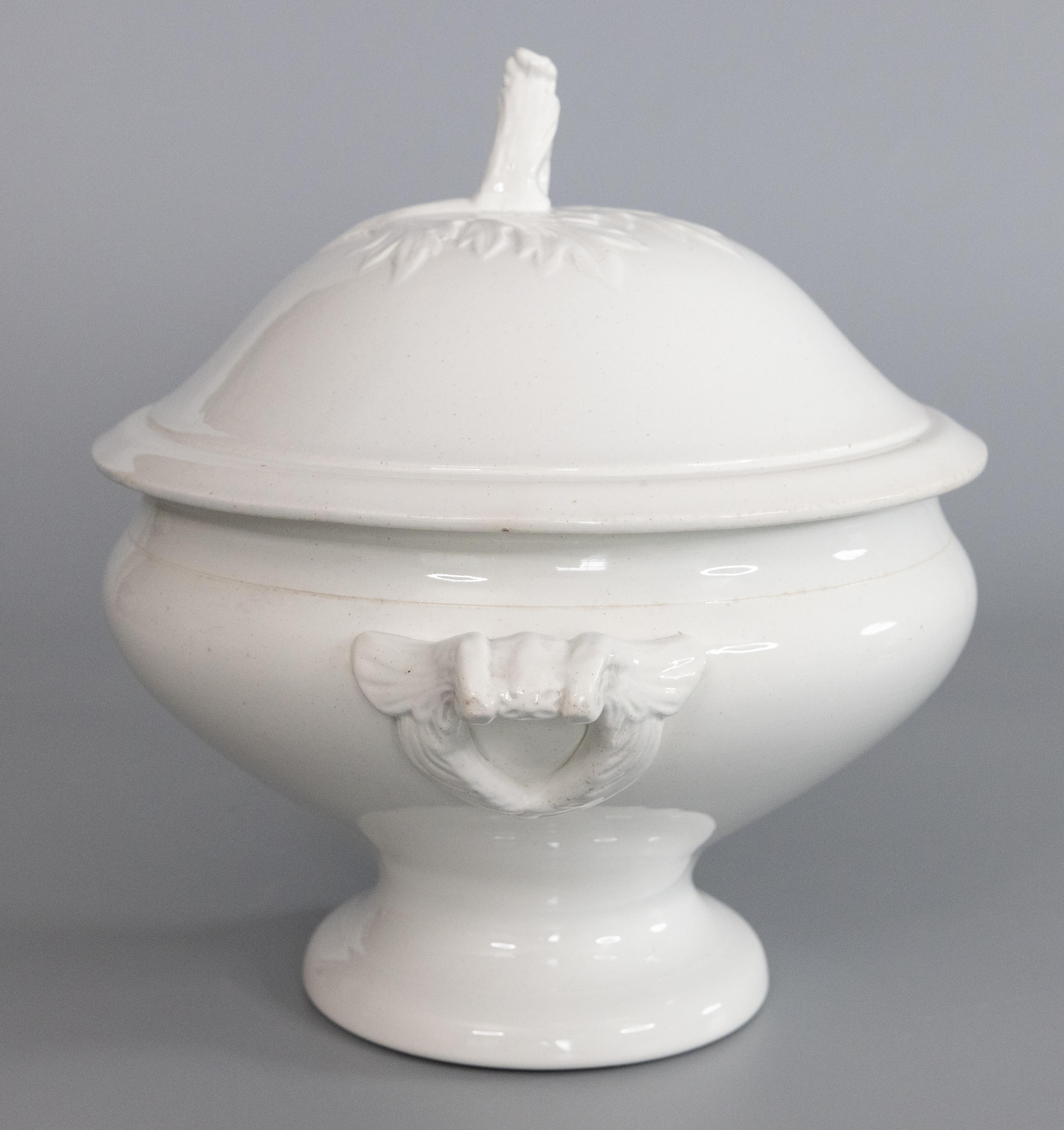 A gorgeous antique early 20th-Century French white ironstone lidded soup tureen. Marked 