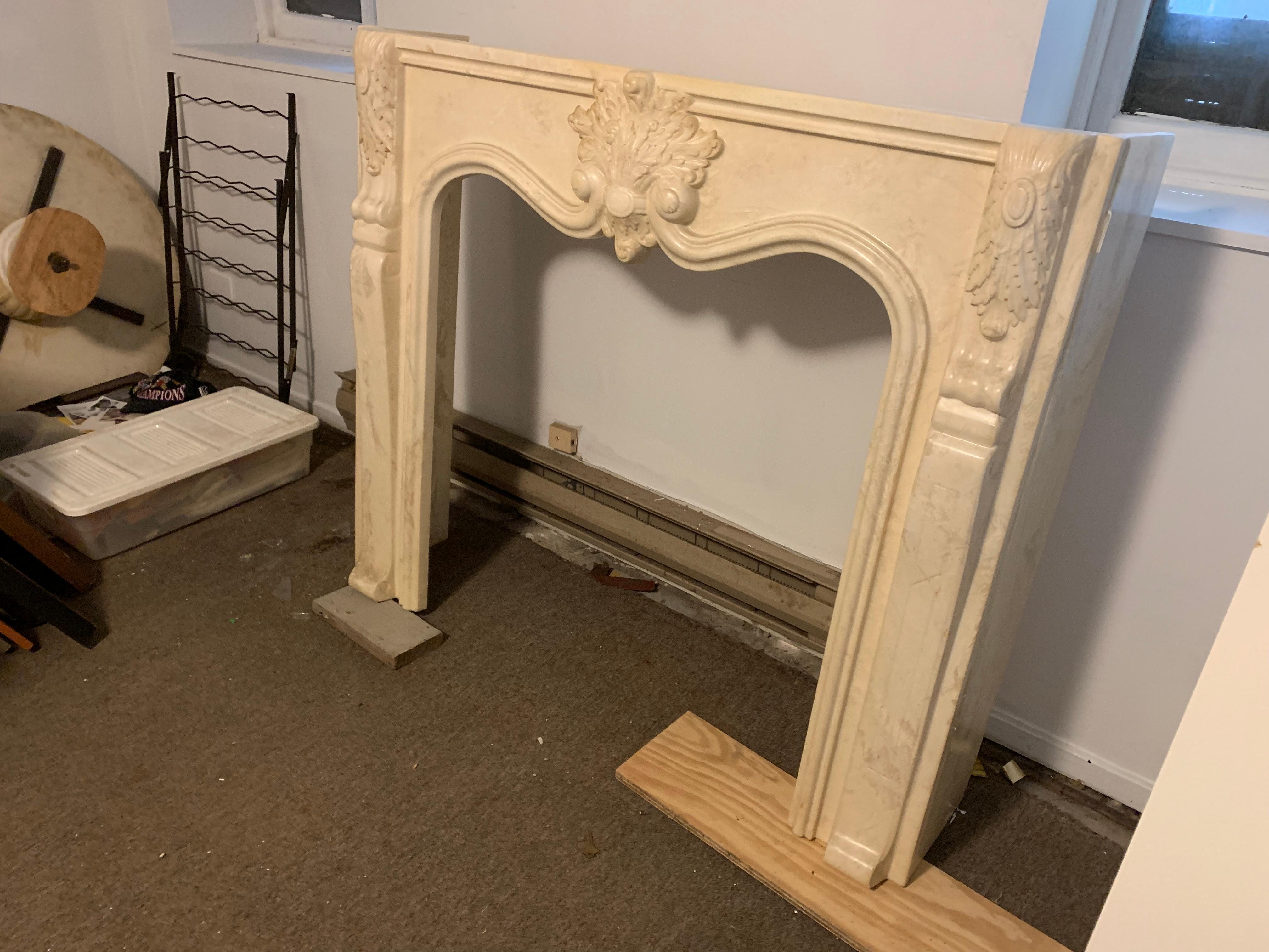 Antique French white marble arched fireplace surround and mantel
White Marble mantel in the Louis XV style with a large central heart and leaf design.
Two pieces, arched base is one piece, top shelf is separate
Well sculpted and beautifully