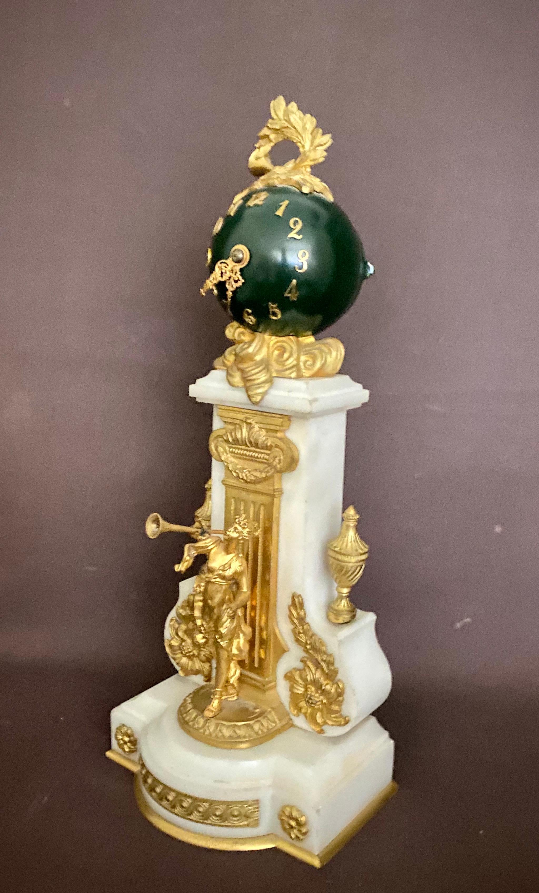 A high quality 19th century French gilt bronze and marble clock, the green ball dial with applied gilt Roman numerals and a Wreath applied to the top.
This is a rare clock measuring 14.5