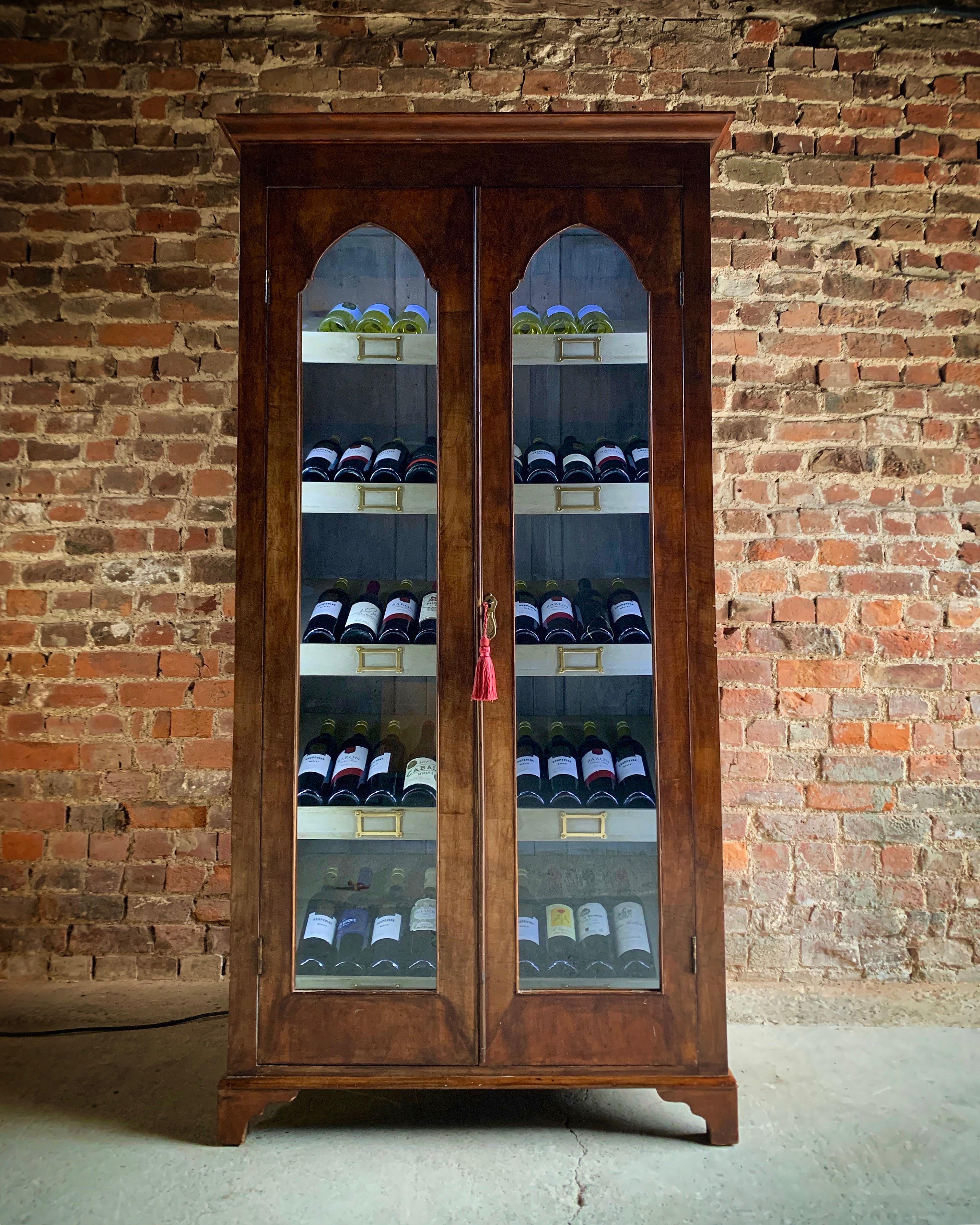 A truly magnificent antique, 19th century French vitrine wine display cabinet, circa 1875, the corniced pediment over two arched shaped glass panelled doors, the painted interior with five angular shelves with a 55 bottle storage capacity, each