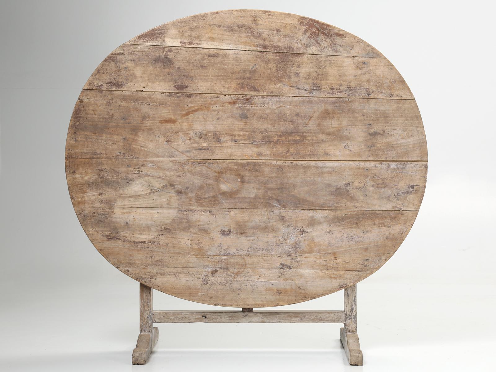 Antique French wine tasting table that was structurally rebuilt, but purposely left in its original well-worn patina.
When standing in its vertical position, the height is 49.63