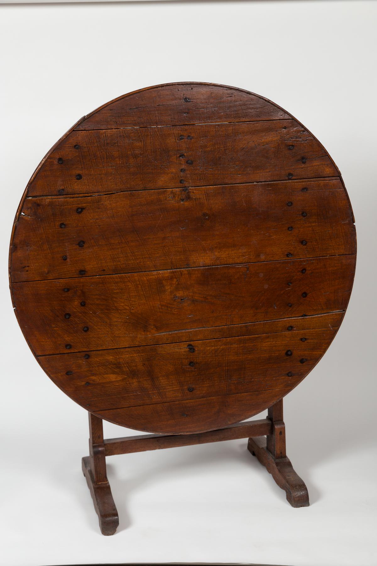 Antique French Wine Tasting Table, late 19th Century. Round table with a turning base that allows the top to flip down. Used in the cellars of French vineyards. Beautiful aged wood patina.
