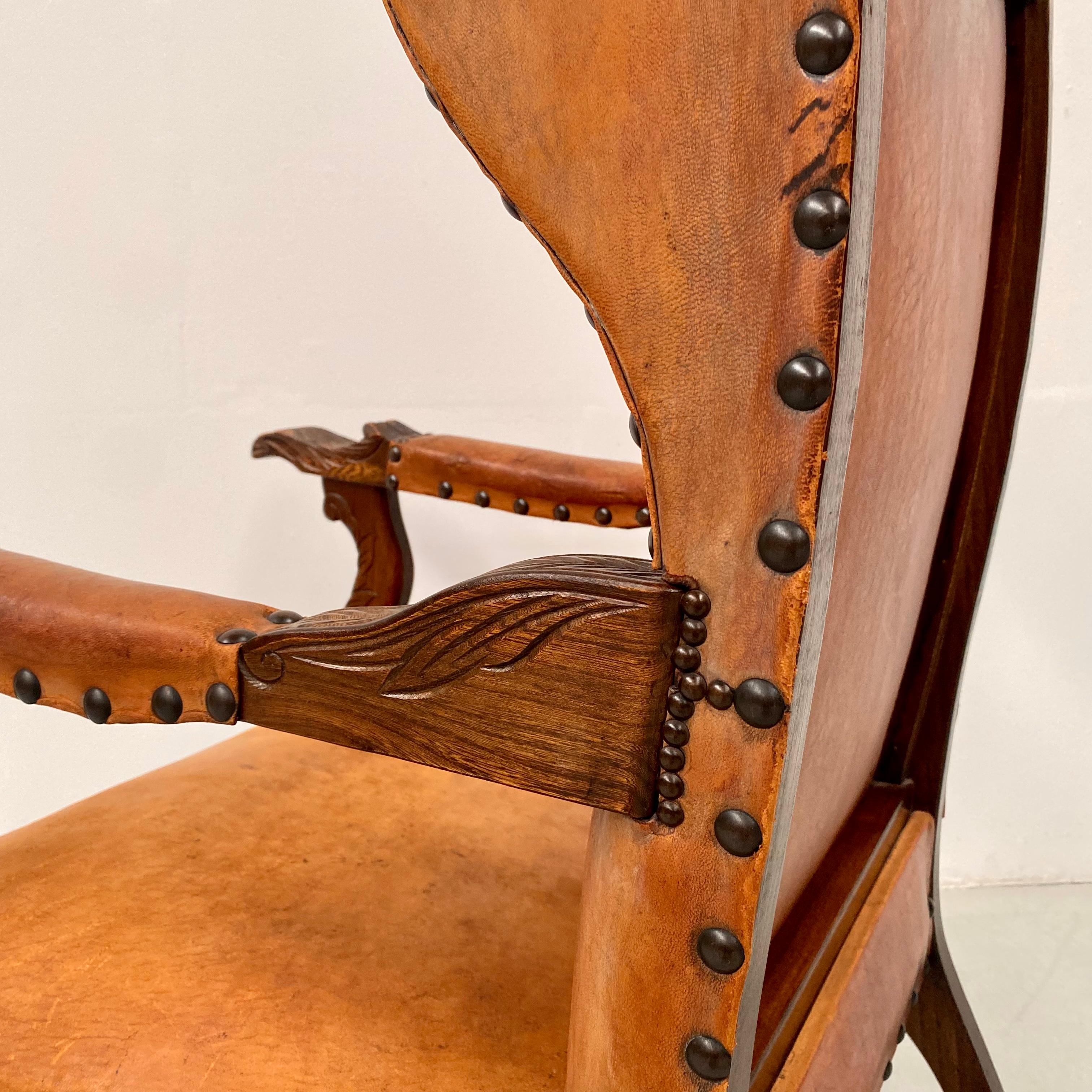 Brutalist Antique French Wingchair in Cognac Leather with Carvings, 1920s.