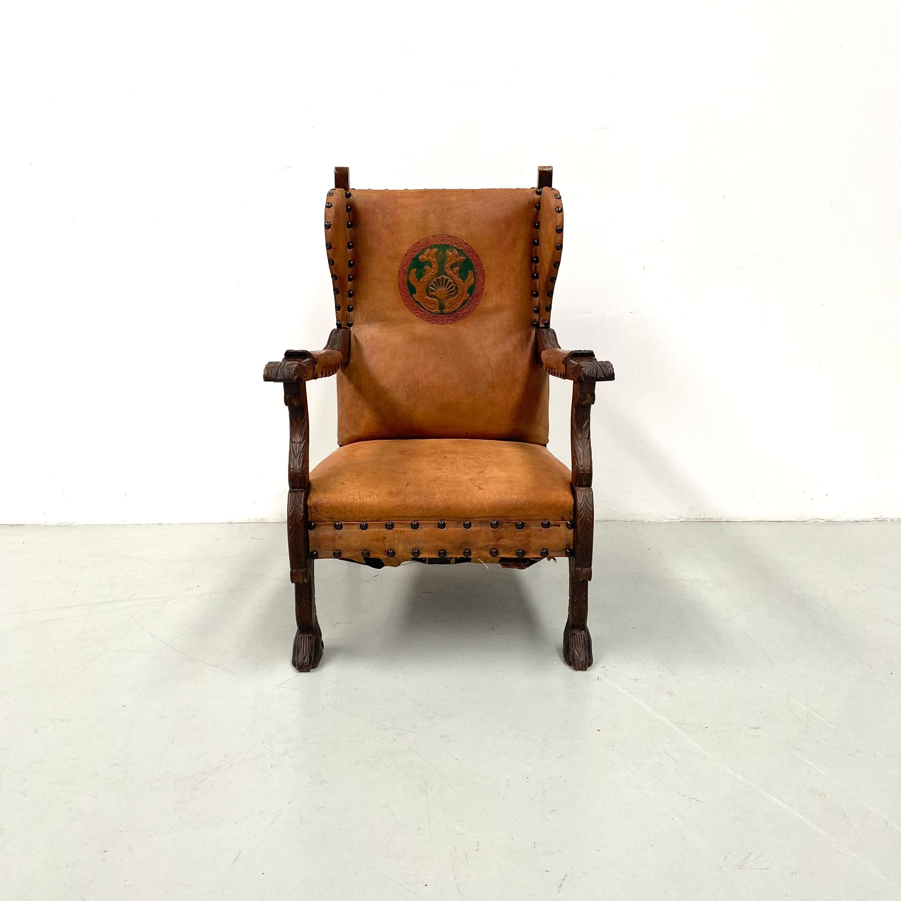 Early 20th Century Antique French Wingchair in Cognac Leather with Carvings, 1920s. For Sale