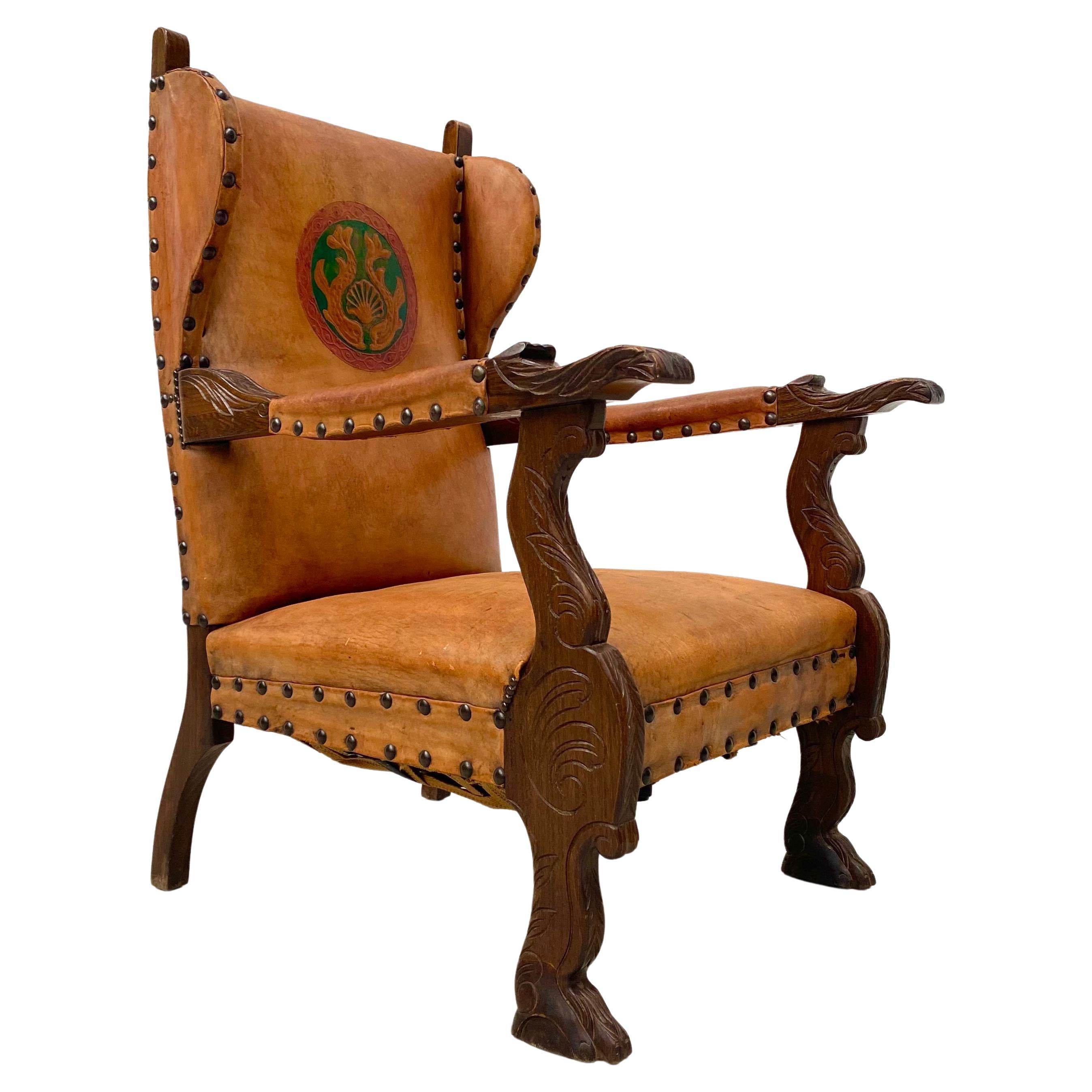 Antique French Wingchair in Cognac Leather with Carvings, 1920s. For Sale