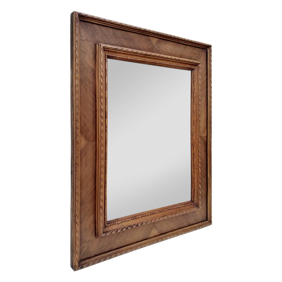 Antique French wood mirror, circa 1940. Antique frame with marquetry and carved wood pearls and rubans decors (Antique frame width: 11.5 cm / 4.33 in.). Modern glass mirror. Antique wood back.