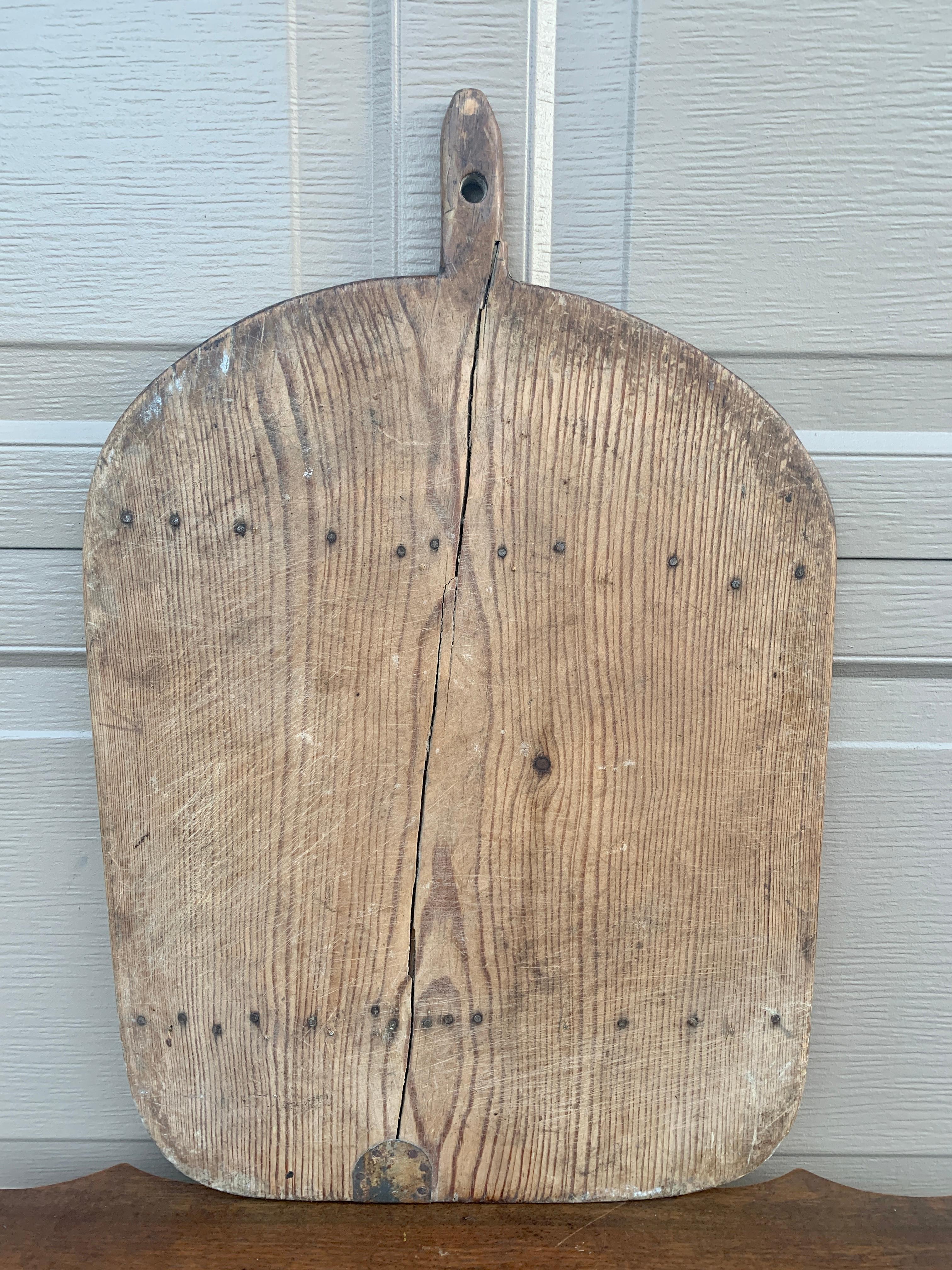A beautiful antique French hand-made bread board that would add character and charm to any space. This piece could be used as wall decor or is ready to serve as a cutting board or serving board for bread, cheese, or charcuterie. 

France, Late 19th