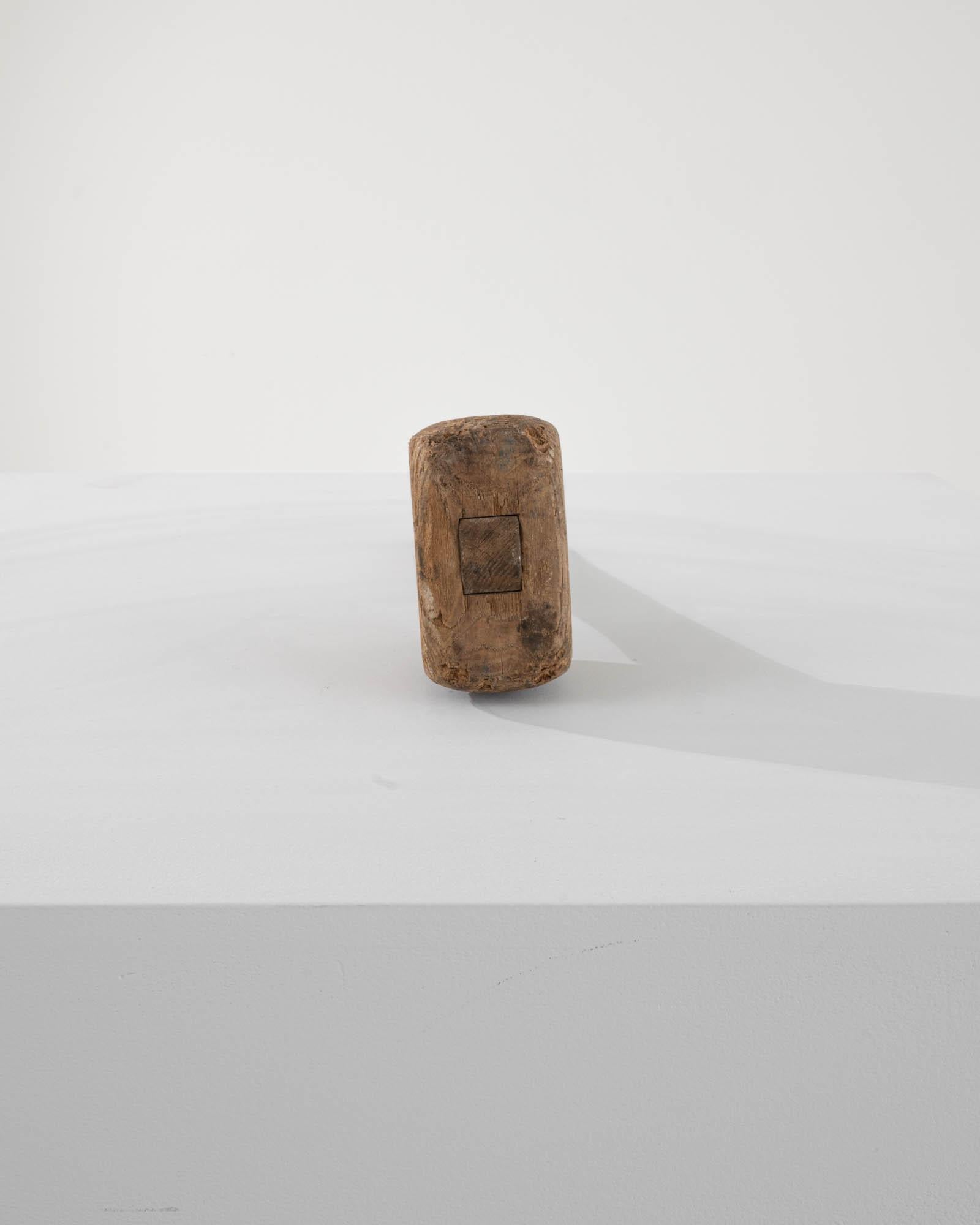 A sturdy object that has gone through hours of work at the hands of a skilled craftsman. This highly collectible wooden mallet from 20th century France also  has its years yet to come; both as a historic piece or aesthetic object, displaying —with a
