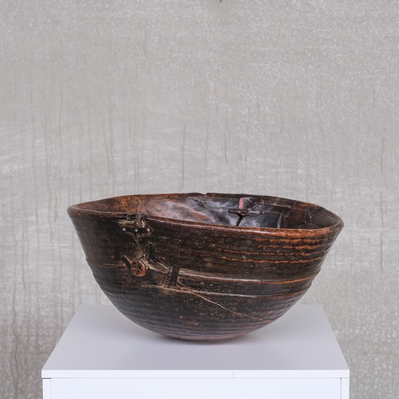 A Primitive style wooden bowl. 

France, 19th century. 

Good size, with historical repairs adding to the character. 

Some wear and historical woodworm (since treated) commensurate with age, but generally good condition. 

Location: Belgium