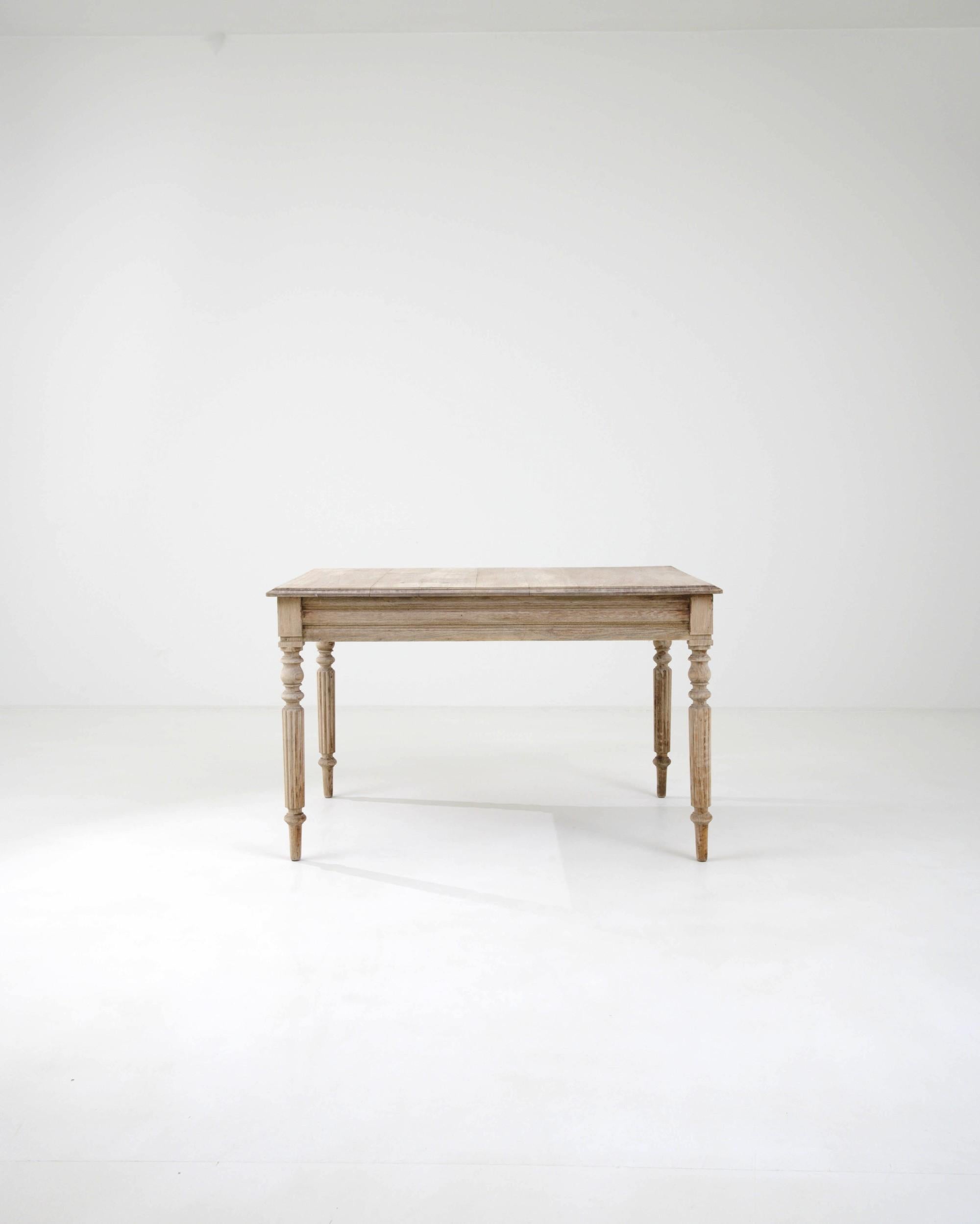 Radiating rustic charm, this antique find effortlessly blends simple and ornate. Made in France circa 1900, this wooden side table is a testament to the craftsmanship of the past. Its subtle carved elements, include a range of simple geometric