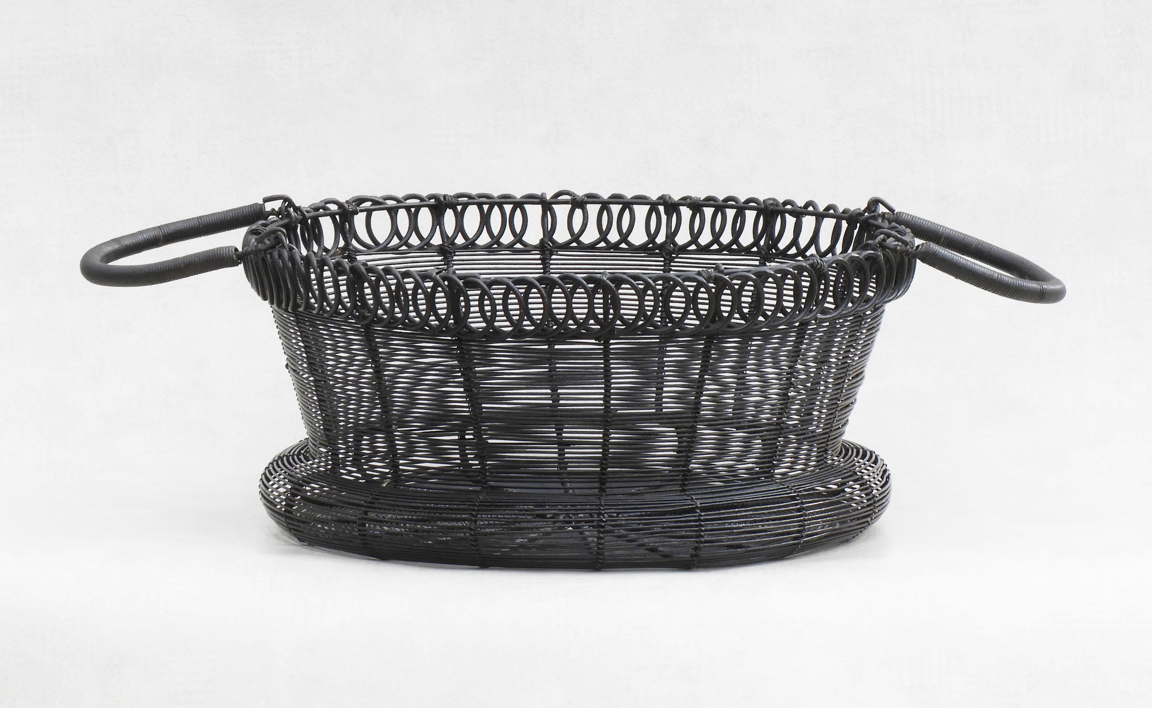 Charming handcrafted Provincial French woven wire work basket, circa 1900. A well-executed nicely shaped 'pannier' with moveable handles and decorative looped edge. Stylish and practical this flat-bottomed basket is perfect for display or storage,