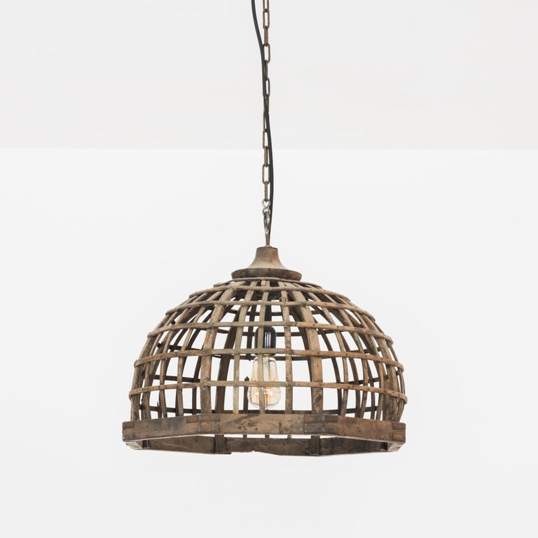 Adapted from a wooden industrial implement from France, circa 1880. Rustic and organic. Vertical wooden slats are interwoven to form a hemisphere. The patinated wood is complimented by iron reinforcements for an industrial appeal. The perceptive use